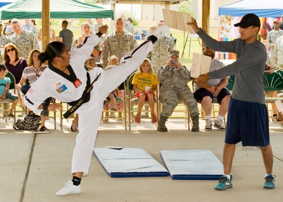 Airman 1st Class Marilou Leyble, 341st Logistics Readiness Squadron vehicle management and analysis technician, demonstrates Taekwondo techniques with the help of Senior Airman Michael Natan, 341st LRS vehicle and equipment apprentice.  (U.S. Air Force photo/Beau Wade)