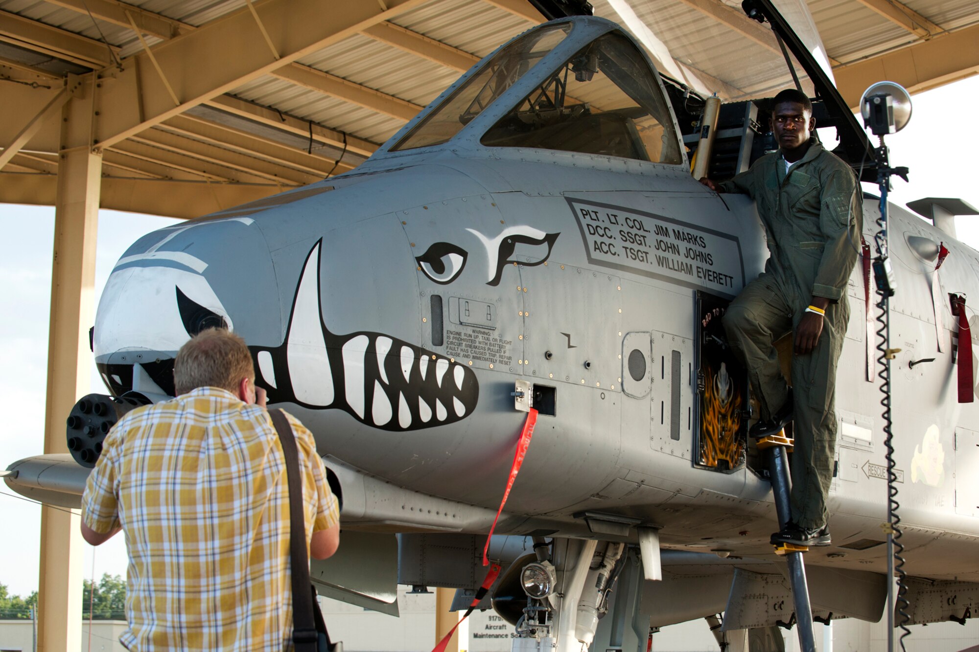 Shreveport Times photographer Jim Hudelson takes "Hero Shots" of Green Oaks High School football quarterback Tre'Davious White on the ladder of a 47th Fighter Squadron A-10 Thunderbolt II, Aug. 16, 2012, Barksdale Air Force Base, La. White is considered to be the "Top Gun" of football for the Shreveport area and is going to play for the Louisiana State University Tigers in Baton Rouge, La. (U.S. Air Force photo by Master Sgt. Greg Steele/Released)