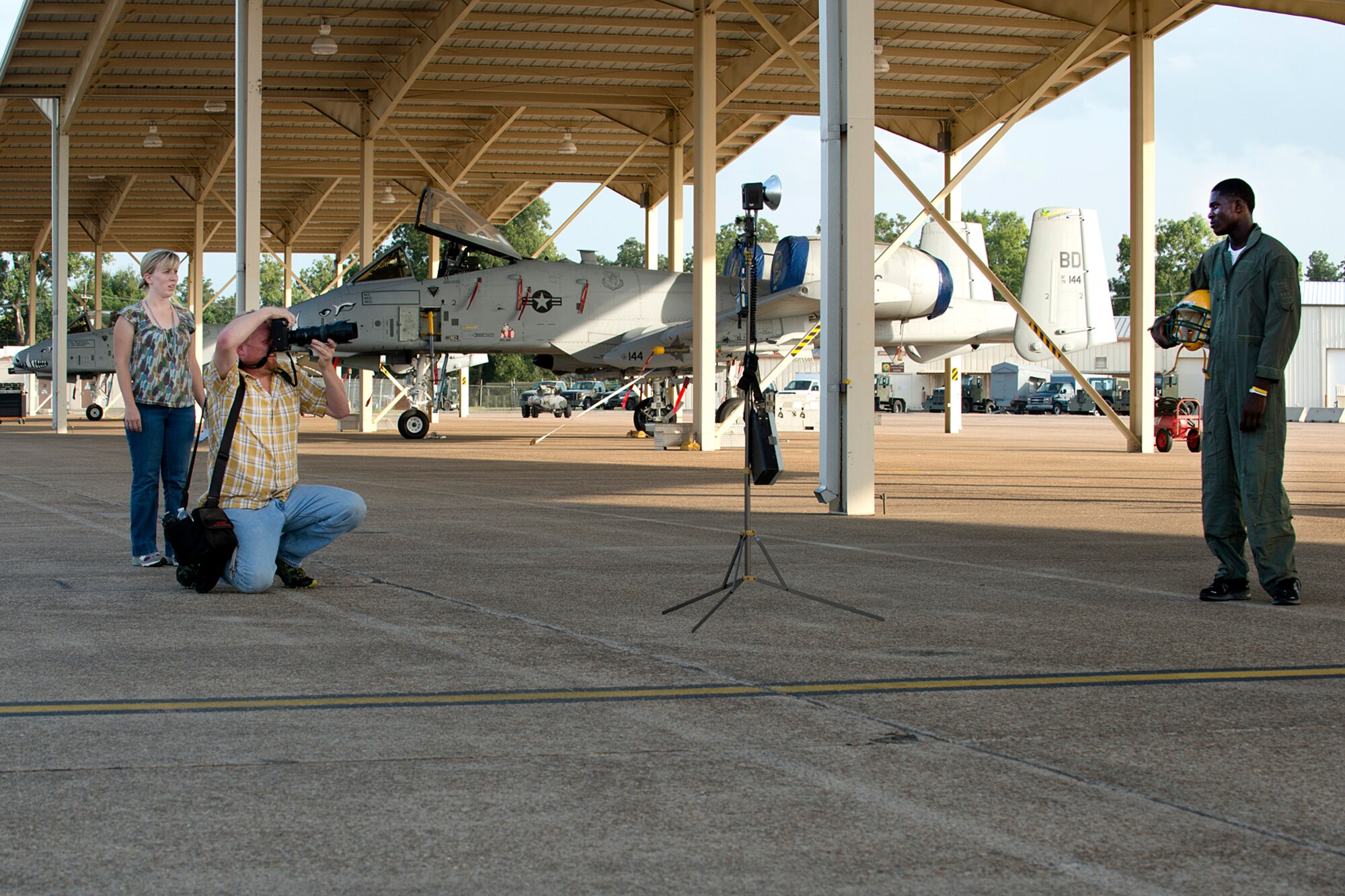 Shreveport Times sports reporter Kelly Morris and photographer Jim Hudelson, use A-10 Thunderbolt II aircraft assigned to the 917th Fighter Group as a background for a sports story on Green Oaks High School football star Tre'Davious White, Aug. 16, 2012, Barksdale Air Force Base, La. The story will portray a top sports performer alongside a top performing aircraft. (U.S. Air Force photo by Master Sgt. Greg Steele/Released)
