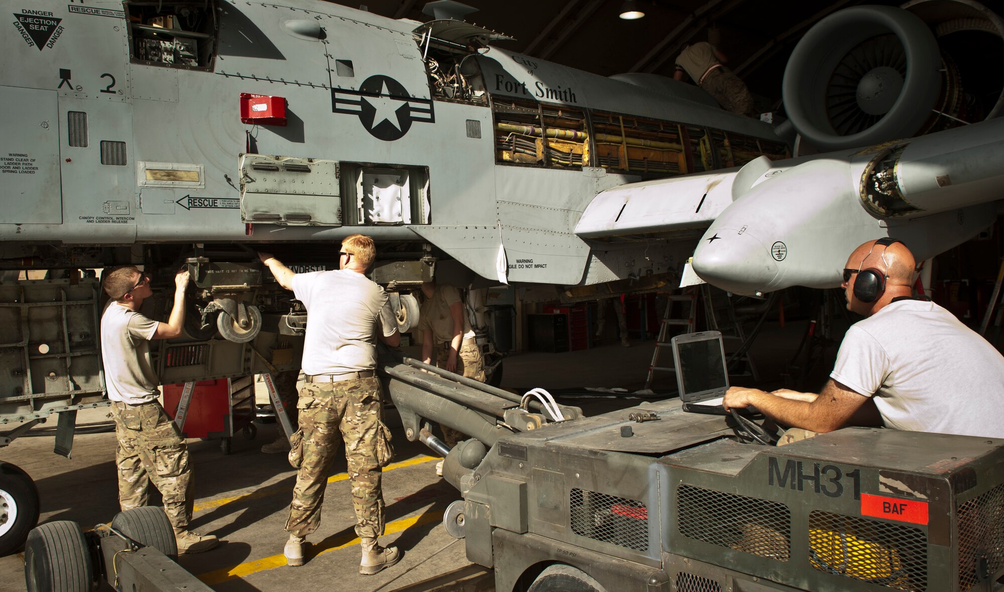 Maintainers with the 188th Aircraft Maintenance Squadron deployed with the 455th Expeditionary Maintenance Squadron work on a 188th Fighter Wing A-10C Thunderbolt II during phase maintenance at Bagram Airfield, Afghanistan, August 8, 2012. While deployed, USAF aircraft endure increased flight hours and more combat maneuvers, which increases the need for routine maintenance and inspections. (U.S. Air Force photo by Capt. Raymond Geoffroy)