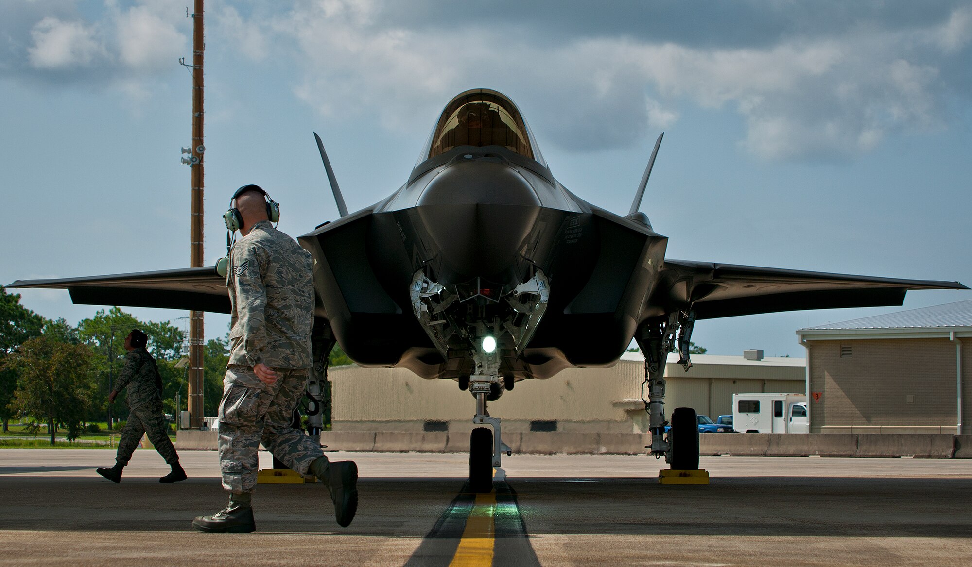 Staff Sgt. Shaun Whittington, of the 57th Aircraft Maintenance Squadron, moves by his F-35A Lightning II joint strike fighter to begin shutdown procedures at Eglin Air Force Base, Fla., Aug. 16.  The sortie marked the 100th F-35A mission flown at Eglin, but also was Whittington’s first time launching the new aircraft.  Whittington is one of three maintainers from Nellis Air Force Base, Nev., being trained on the F-35.  Once their training is complete, they’ll provide maintenance support to the 422nd Test and Evaluation Squadron’s F-35 fleet.  The 422nd is a geographically separated unit of the 53rd Wing, headquartered at Eglin. (U.S. Air Force photo/Samuel King Jr.)