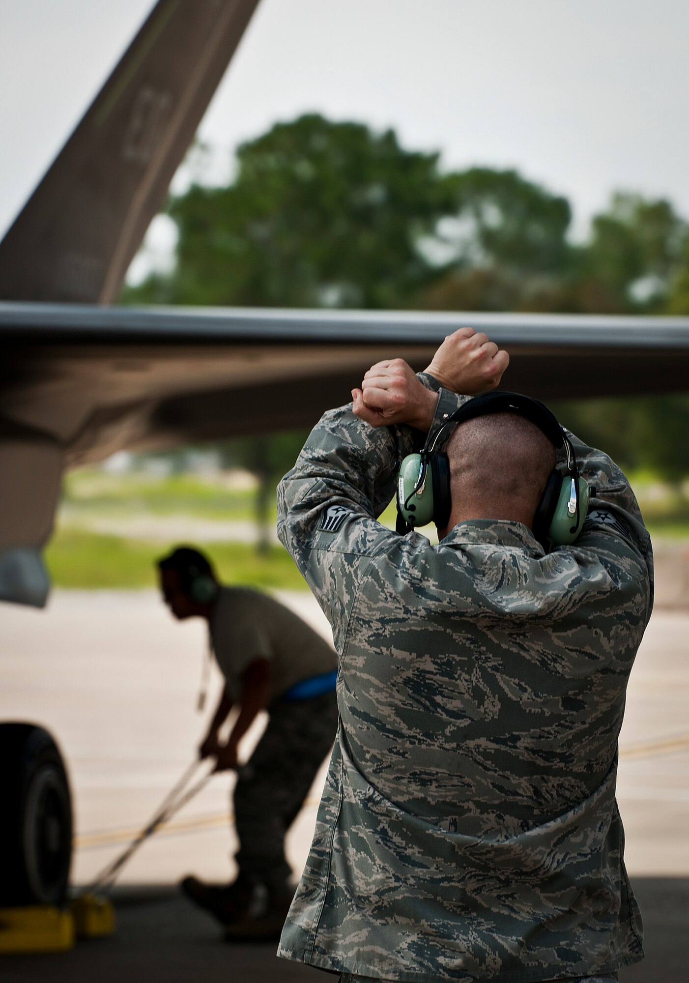 Staff Sgt. Shaun Whittington, of the 57th Aircraft Maintenance Squadron, marshals in his F-35A Lightning II joint strike fighter after its sortie at Eglin Air Force Base, Fla., Aug. 16.  The sortie marked the 100th F-35A mission flown at Eglin, but also was Whittington’s first time launching the new aircraft.  Whittington is one of three maintainers from Nellis Air Force Base, Nev., being trained on the F-35.  Once their training is complete, they’ll provide maintenance support to the 422nd Test and Evaluation Squadron’s F-35 fleet.  The 422nd is a geographically separated unit of the 53rd Wing, headquartered at Eglin. (U.S. Air Force photo/Samuel King Jr.)