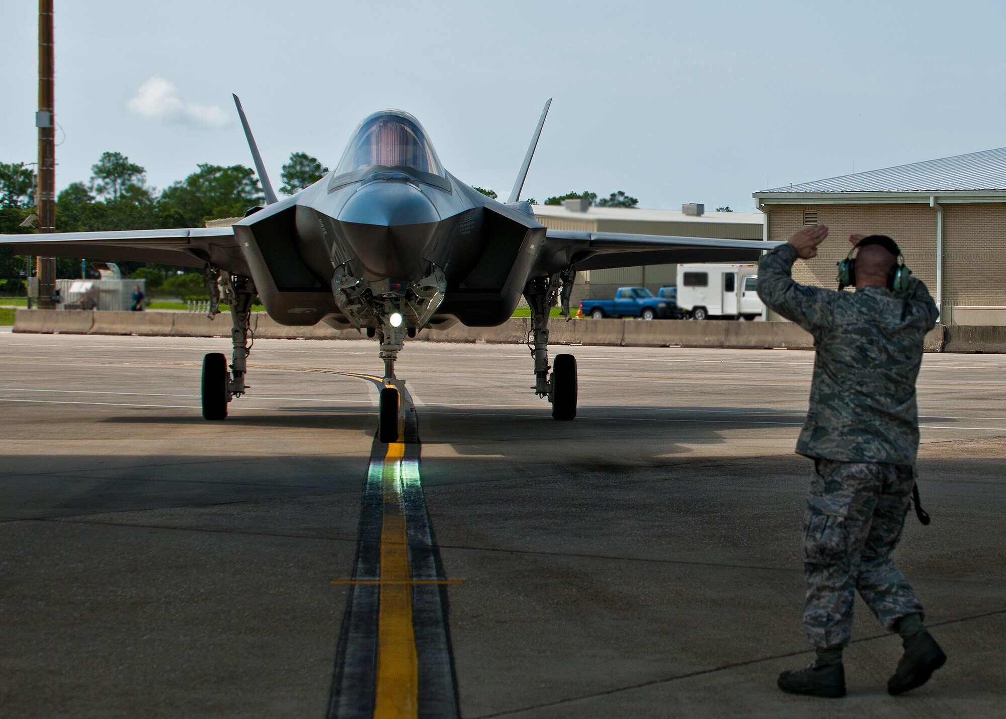 Staff Sgt. Shaun Whittington, of the 57th Aircraft Maintenance Squadron, marshals in his F-35A Lightning II joint strike fighter after its sortie at Eglin Air Force Base, Fla., Aug. 16.  The sortie marked the 100th F-35A mission flown at Eglin, but also was Whittington’s first time launching the new aircraft.  Whittington is one of three maintainers from Nellis Air Force Base, Nev., being trained on the F-35.  Once their training is complete, they’ll provide maintenance support to the 422nd Test and Evaluation Squadron’s F-35 fleet.  The 422nd is a geographically separated unit of the 53rd Wing, headquartered at Eglin. (U.S. Air Force photo/Samuel King Jr.)