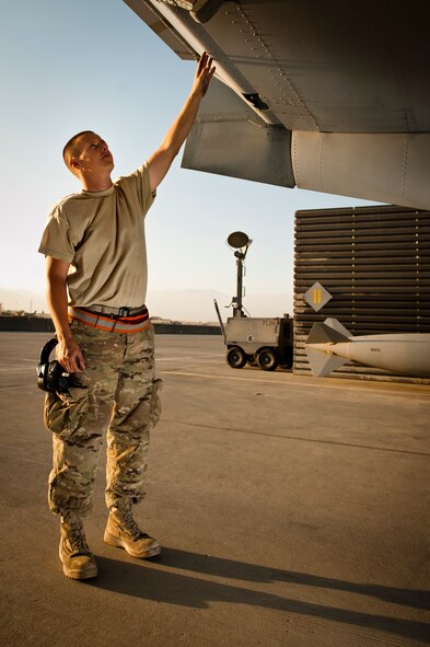 Senior Airman Wes Pool, a 188th Aircraft Maintenance Squadron A-10 crew chief currently deployed with the 455th Expeditionary Aircraft Maintenance Squadron, points out a patched hole in his U.S. Air Force A-10 Thunderbolt II at Bagram Airfield, Afghanistan, July 7, 2012. Pool had the plane patched and ready to fly less than 24 hours after it took direct fire from enemy forces while providing close-air support to ambushed coalition forces in eastern Afghanistan on June 28, 2012. (U.S. Air Force photo by Capt. Raymond Geoffroy)