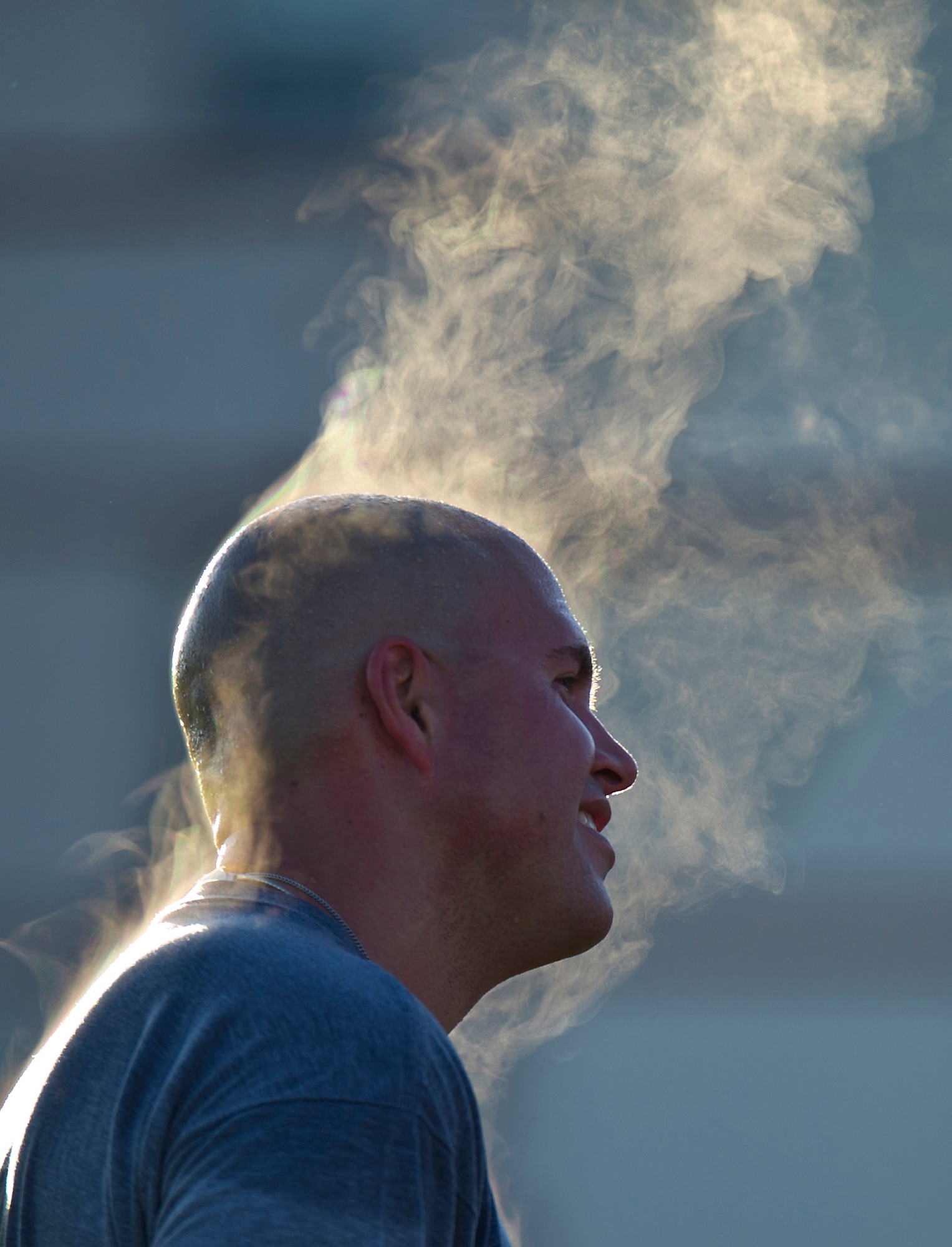 JOINT BASE ELMENDORF-RICHARDSON, Alaska --  U.S. Army Sgt. Nicholas Dockum, 4th Quartermaster Detachment (Airborne) grins after the 2d Engineer Brigade morning run on Joint Base Elmendorf-Richardson, Tuesday, Aug. 7, 2012, as steam rises from his head on a cool Alaska morning.  Brigade Commander U.S. Army Col. Thomas J. Roth led the brigade during the run as morale-building exercise for his Soldiers, and a kick-off to unit organization festivities for 2d Engineer Brigade Soldiers and their Families called Arctic Trailblazer Week.  (U.S. Air Force photo by Justin Connaher)