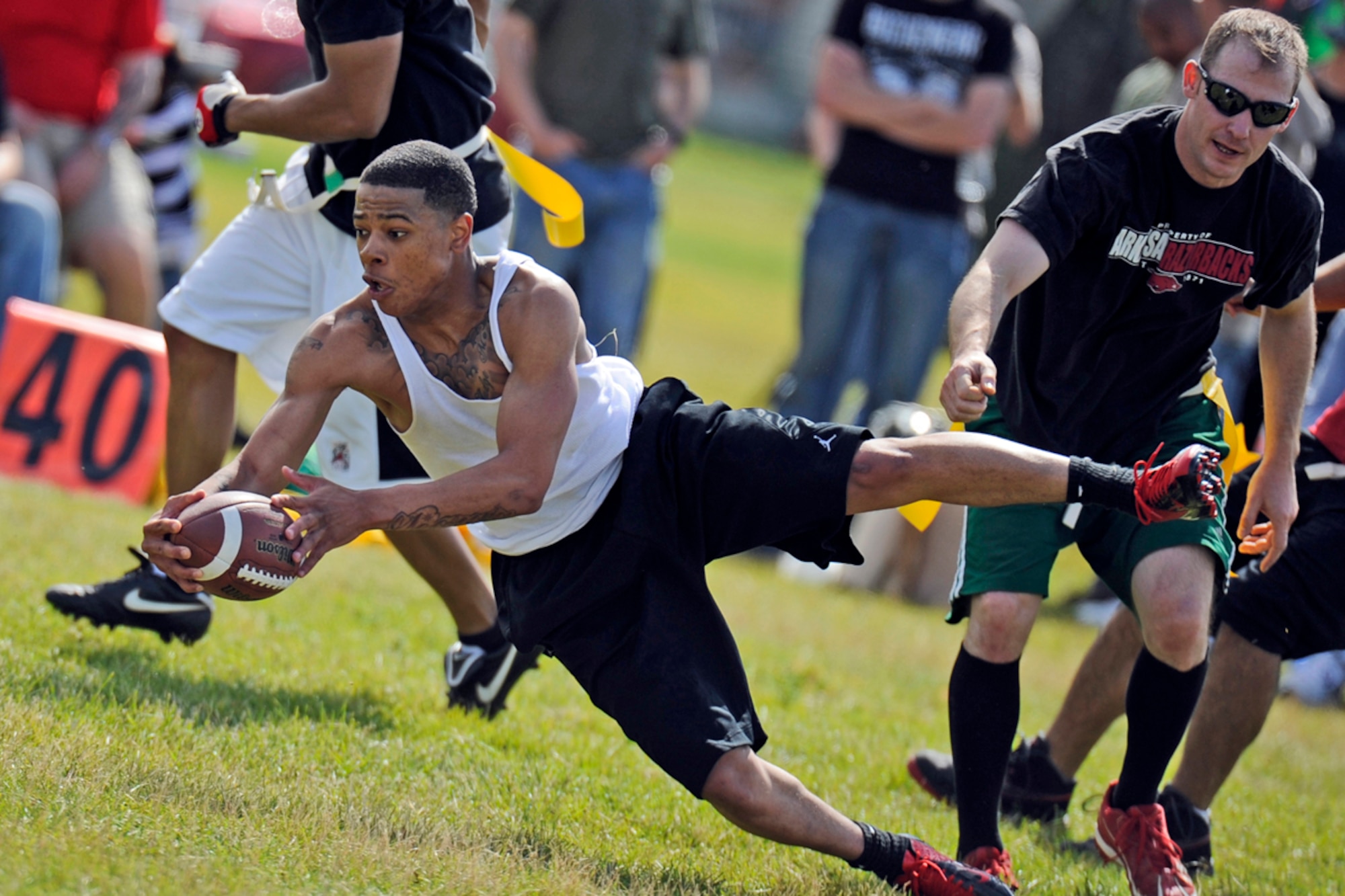 JOINT BASE ELMENDORF-RICHARDSON, Alaska --  Sergeant 1st Class Jeffrey Ransick, 545th Military Police Company, of El Paso, Texas, right, pulls a flag from Private 1st Class Randavius Balom, 40th Quartermaster Company, of  Pelham, Ga., in a flag football game during the unit organization festivities for 2d Engineer Brigade Soldiers and their Families called Arctic Trailblazer Week, Tuesday, Aug. 7, 2012.  (U.S. Air Force photo by Justin Connaher)