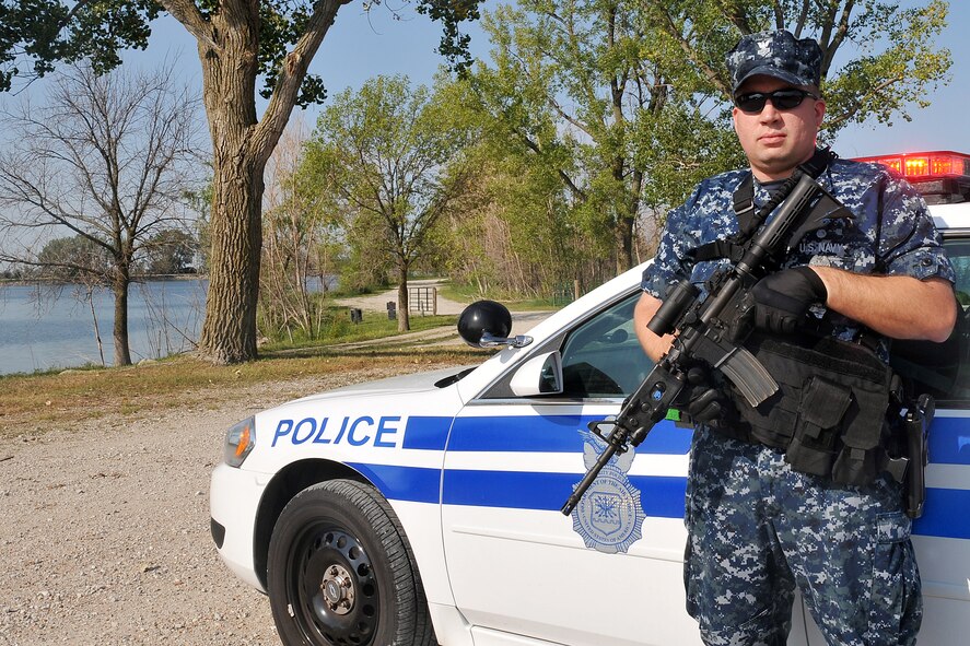 U.S. Navy Petty Officer 1st Class Edward Witt, 55th Security Forces Squadron, protects the entry point during a major accident response exercise on Offutt AFB, Neb., Aug. 11. Team Offutt members and several agencies from the surrounding Omaha metro area participate in this exercise to practice the emergency response necessary for a large scale medical incident. (U.S. Air Force photo by Charles Haymond/Released)