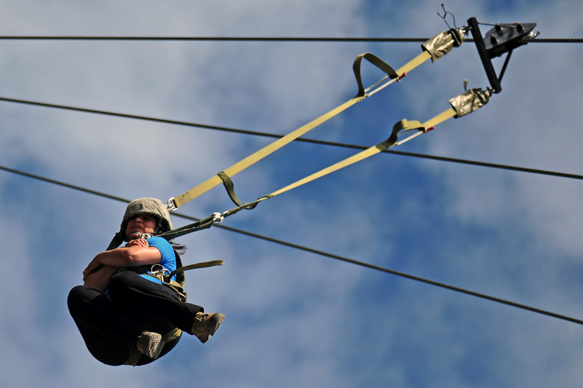 JOINT BASE ELMENDORF-RICHARDSON, Alaska --  Ivette Perez, of New York, NY, wife of Sgt 1st Class Victor Perez, Headquarters and Headquarters Company 6th Engineer Battalion, of New York, NY, slides down a guide wire after exiting a jump tower used by paratroopers for training during the unit organizational festivities for 2d Engineer Brigade Soldiers and their Families called Arctic Trailblazer Week, Thursday, Aug. 9, 2012.  (U.S. Air Force photo by Justin Connaher)