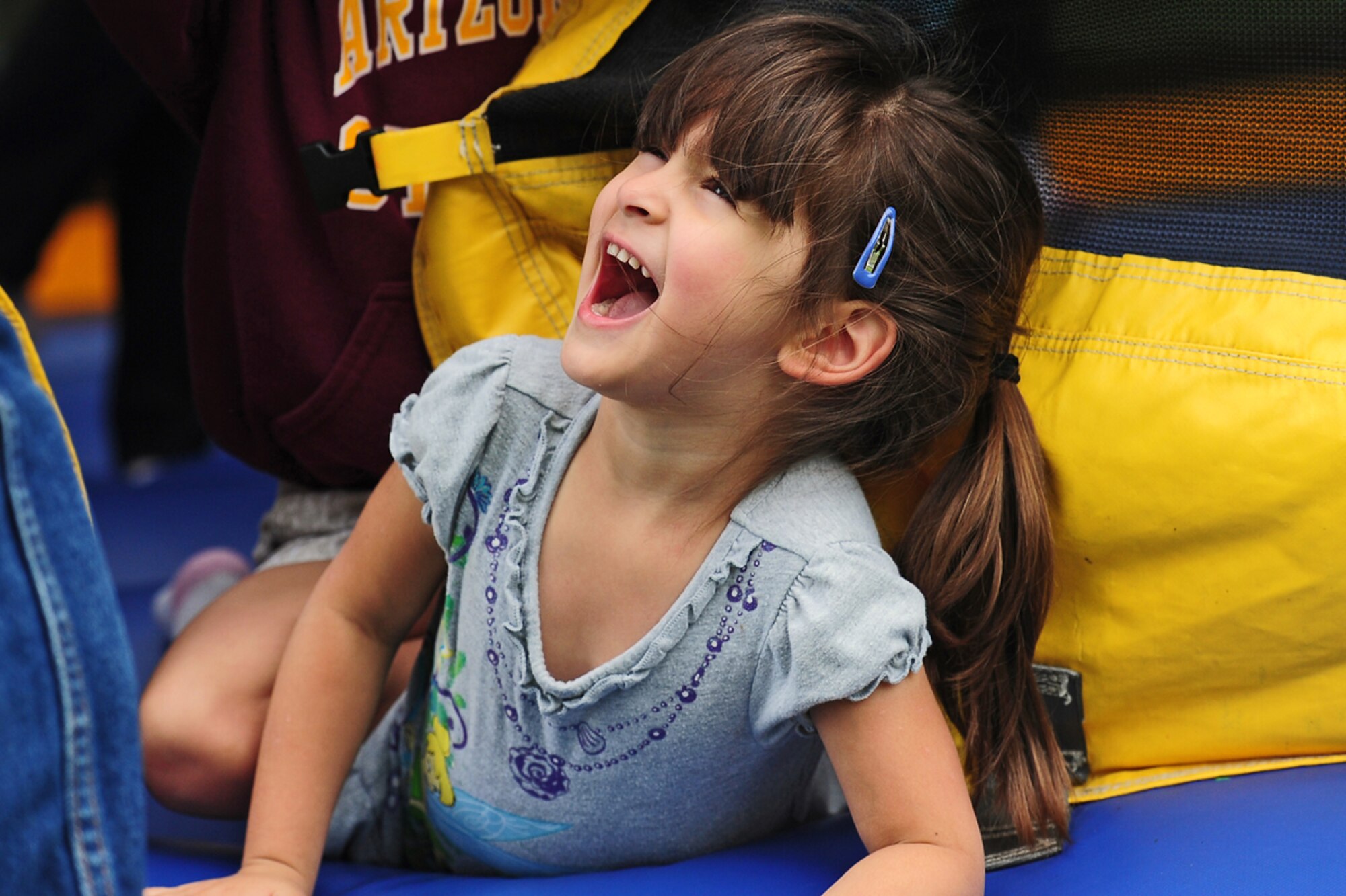 JOINT BASE ELMENDORF-RICHARDSON, Alaska --  Carly Churde, 3, daughter of U.S. Army Sgt. Edward Churde, Forward Support Company 6th Engineer Battalion, of San Antonio, Texas, laughs as she climbs out of a bouncy house during the unit organizational festivities for 2d Engineer Brigade Soldiers and their Families called Arctic Trailblazer Week, Friday, Aug. 10, 2012.  Arctic Trailblazer Week culminated with a brigade picnic, food, games, music and awards for individuals, groups and the Best Battalion Cup.  (U.S. Air Force photo by Justin Connaher)