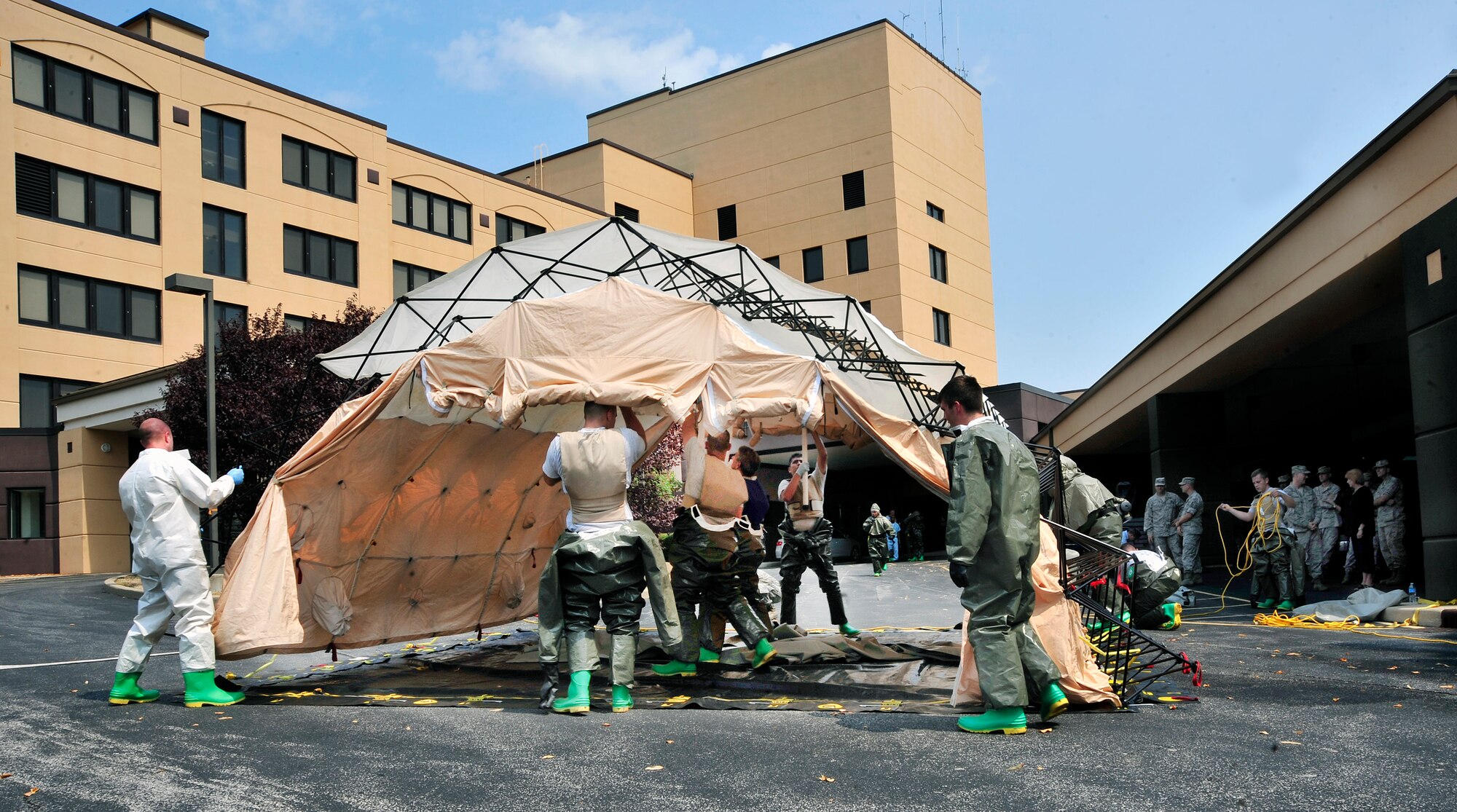 Members from the 375th Medical Group set up a tent during an In-Place Patient Decontamination Sustainment Training exercise at Scott Air Force Base, Ill Aug. 16, 2012. The tent was used to simulate cleaning patients with soap ridding them of chemical agents after an attack. The IPDS training is required to be conducted every 90 days. (U.S. Air Force photo/ Staff Sgt. Stephenie Wade)