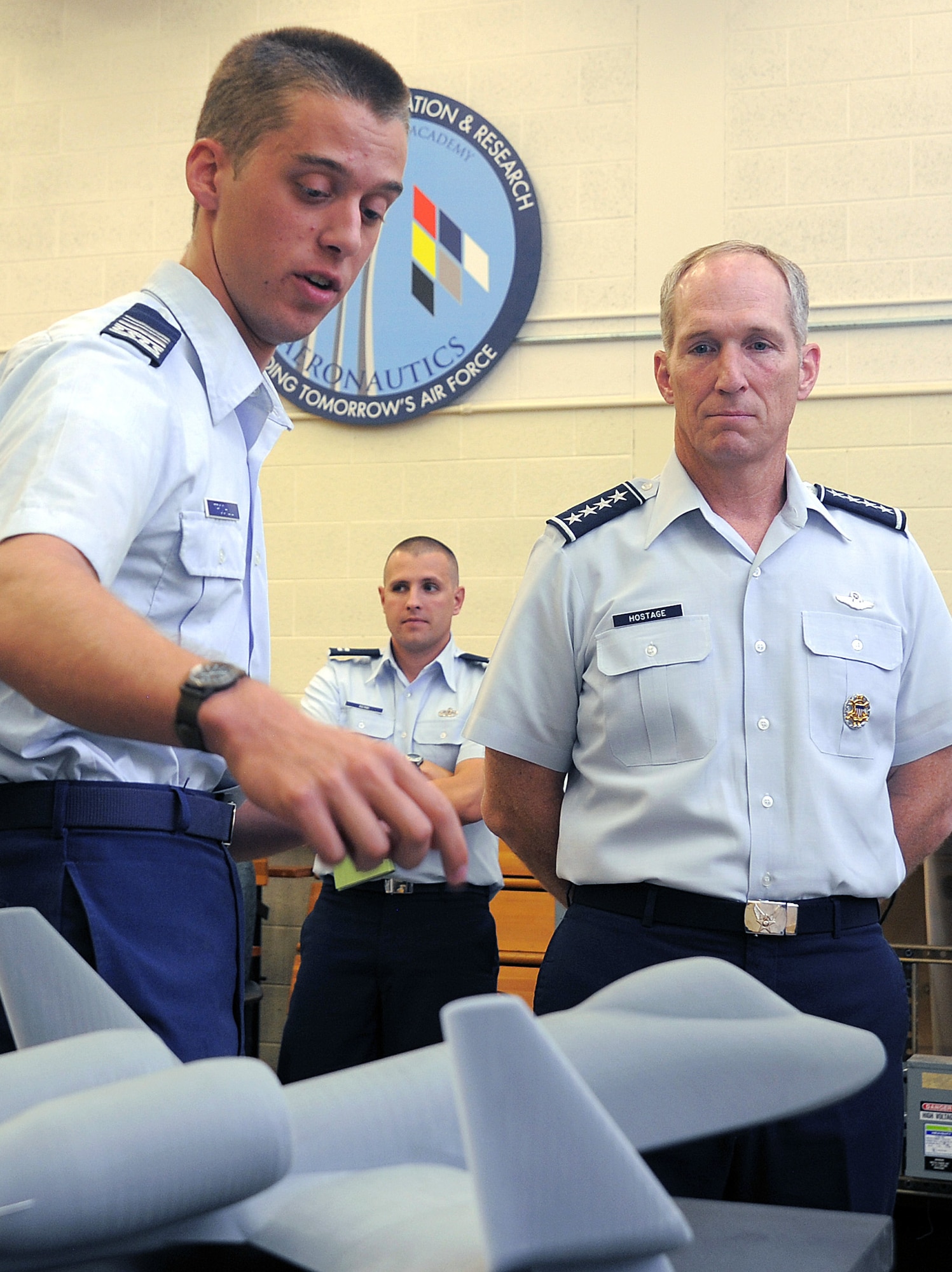 Cadet 1st Class Steven Trochlil discusses aeronautics research with Gen. Mike Hostage during the general's visit to the Air Force Academy Aug. 14, 2012. Hostage, the commander of Air Combat Command, has more than 4,000 flying hours in numerous Air Force aircraft. Trochlil is assigned to Cadet Squadron 04. (U.S. Air Force photo/Raymond McCoy)