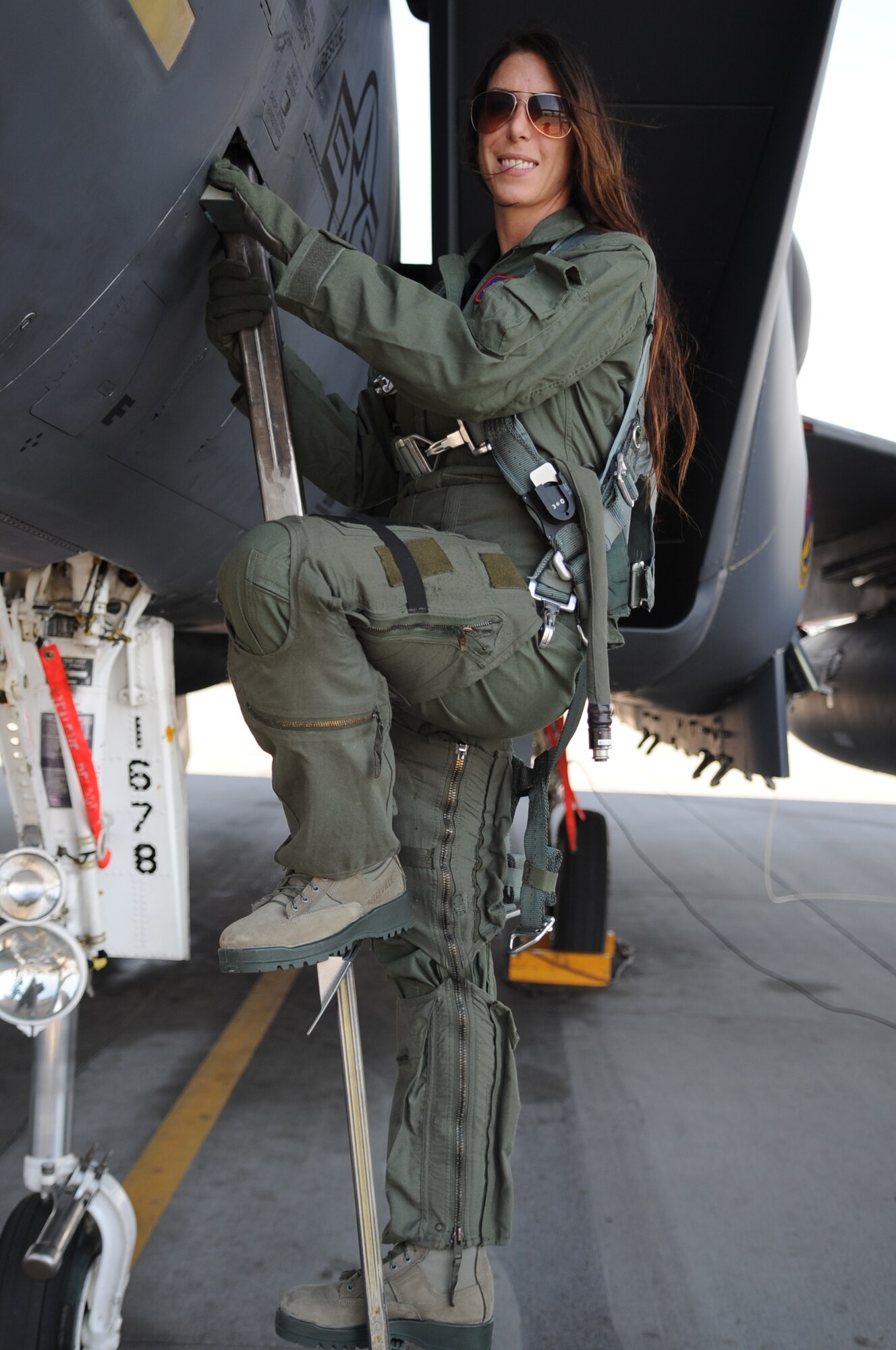 Professional NHRA driver Alexis DeJoria posses for her “hero shot” following her F-15E Strike Eagle orientation flight with the 389th Fighter Squadron at Mountain Home Air Force Base, Aug. 7, 2012. During the flight DeJoria experience aggressive maneuvering, aerobatics, low-level flying over canyons and a supersonic run. (U.S. Air Force photo/Staff Sgt. Roy Lynch)