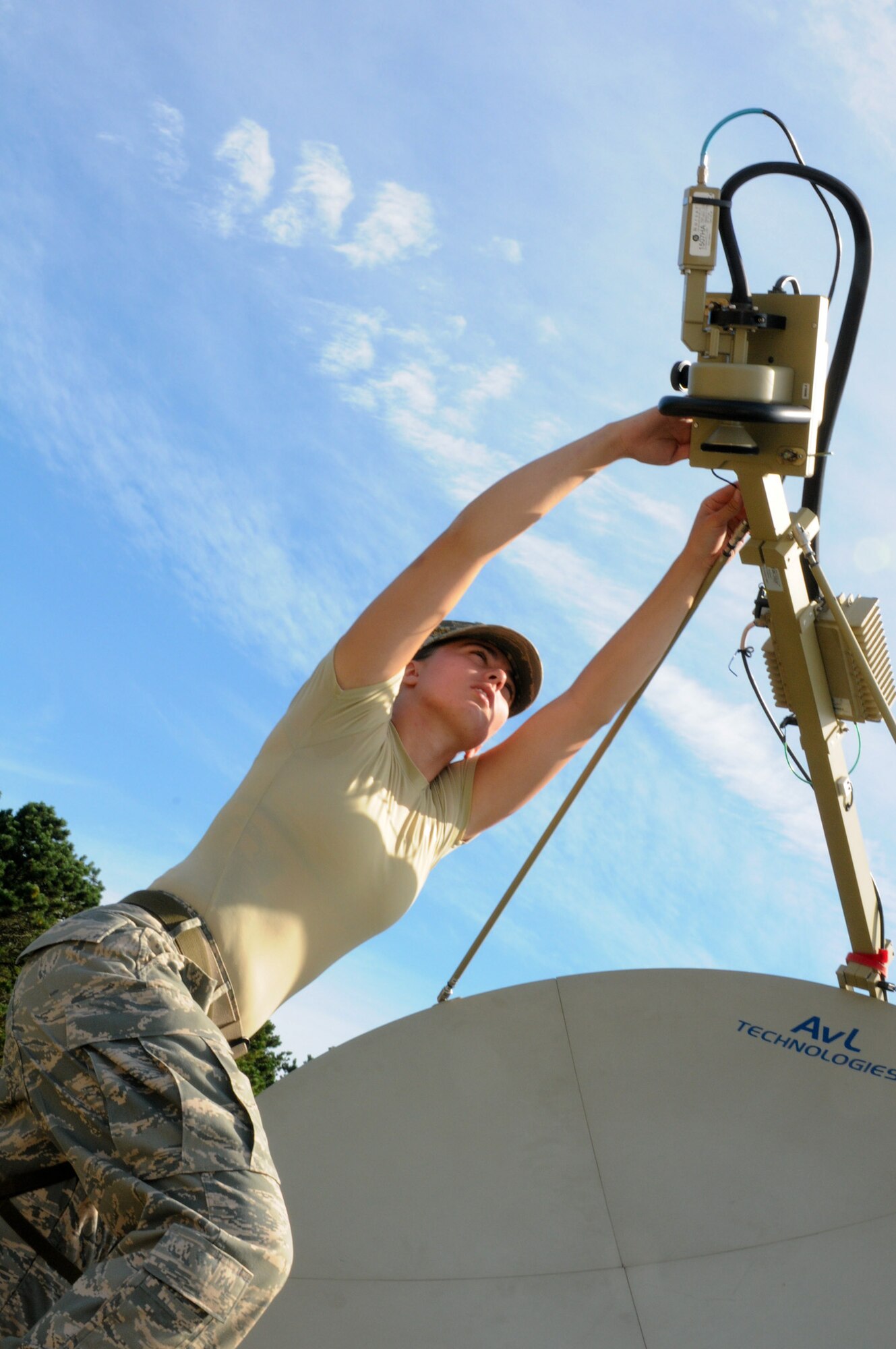 Senior Airman Julia Massi, 267th Combat Communications Squadron (267 CBCS), sets up a satellite transmitter as part of the Joint Incident Site Communications Capability (JISCC) facility during a Homeland Response Force (HRF) training exercise at Camp Edwards, Mass., Aug. 8. The 267 CBCS provided the primary communication tools for the week-long exercise. (National Guard photo by Tech. Sgt. Kerri Cole/Released)