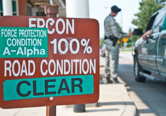 A sign in front of F. E. Warren Gate 1 indicates a 100 percent identification check is in progress. (U.S. Air Force photo by Airman 1st Class Jason Wiese)