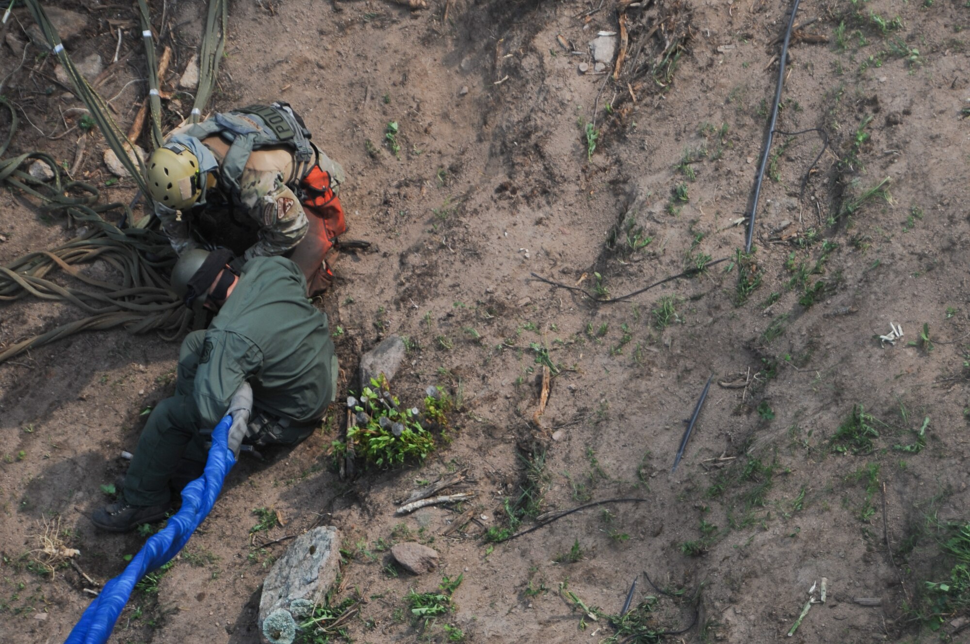 After clearing the area of marijuana plants, counterdrug personnel load the plants into a net and secure the net to a helicopter hoist for extraction from a remote hillside near Rye, Colo., Aug. 15, 2012. Using a UH-60 helicopter, Colorado National Guardsmen helped move an estimated 7,000 to 9,000 marijuana plants -- nearly $15 million street value -- from two remote grow sites located on private property. Members of the Colorado National Guard Joint Counter-Drug Task Force's Drug Interdiction section were called to assist the Pueblo County Sheriff's Office move the plants, which are growing in steep terrain that's impassible by motor vehicle. The operation is largest marijuana bust in Pueblo County history and one of the largest ever in Colorado. (Official Air National Guard photo by Master Sgt. Cheresa D. Theiral)