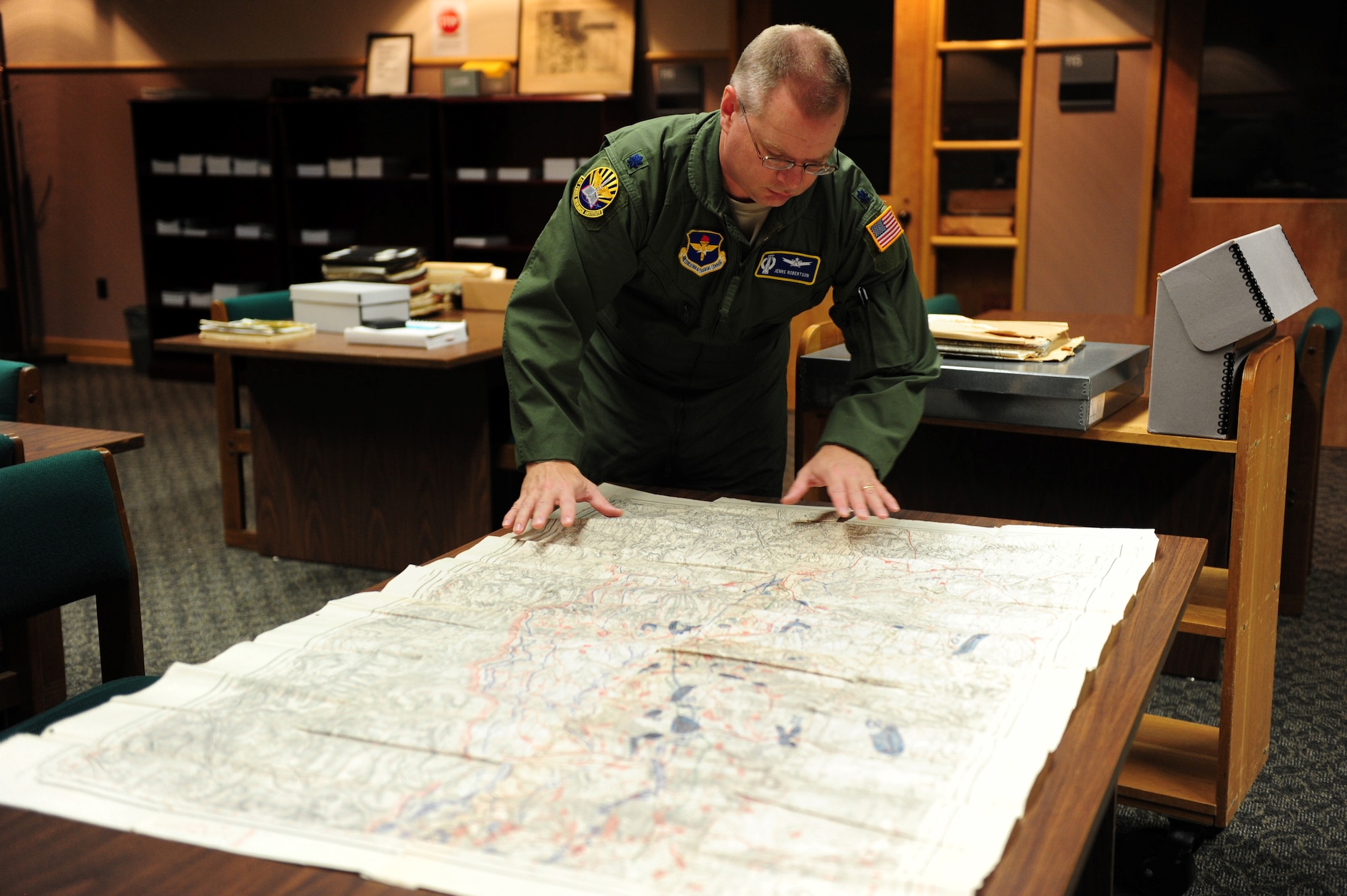 Lt. Col. Jenns Robertson, Air and Space Power Strategist at the Air Force Research Institute, researches information for Theater History of Operations at Maxwell Air Force Base Aug. 17. THOR is database of bombs dropped from American military aircraft from World War One through current times. (U.S. Air Force photo by Master Sgt. Michael Voss)