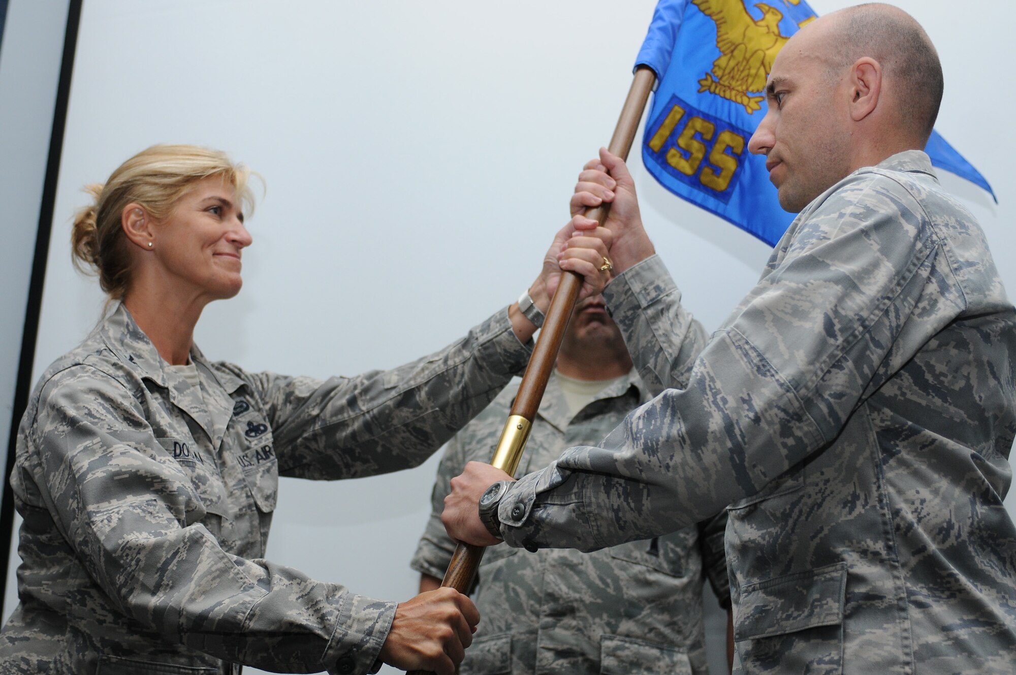 Col. Virginia Doonan, 102nd Intelligence Group commander, gives the 102nd Intelligence Support Squadron (102 ISS) guidon to Lt. Col. Enrique, incoming 102 ISS commander, during a formal change of command ceremony held at Otis Air National Guard Base, Mass., Aug. 16. A change of command is a military tradition that represents a formal transfer of authority from one commander to the next. (Air National Guard photo by Tech. Sgt. Kerri Cole/Released)
