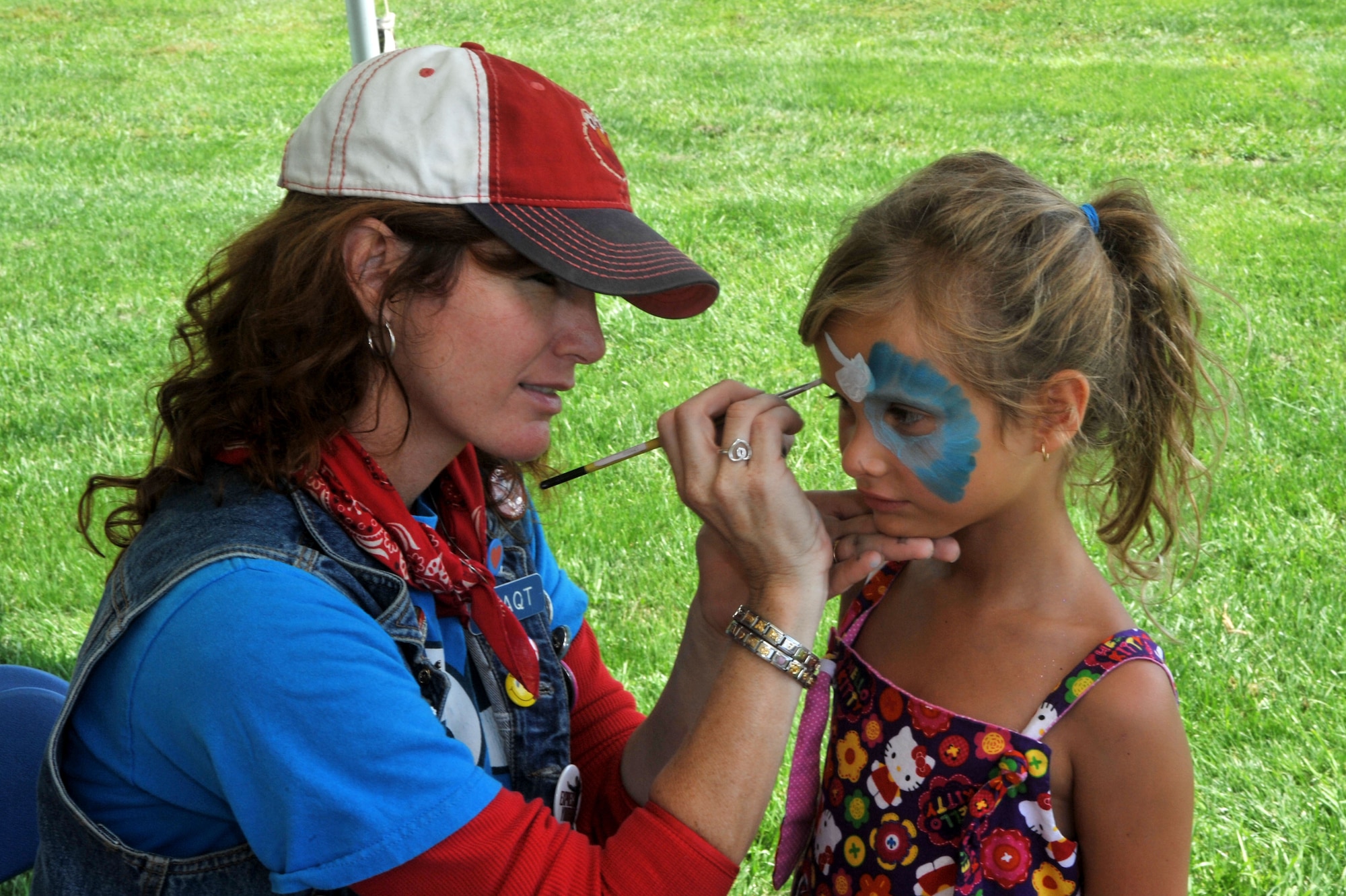 Hailey Williams, gets her face painted by Dana O'Brien, from Party Express, during the 2011 Joint Base McGuire-Dix-Lakehurst picnic at John Mann Park here. (U.S. Air Force Photo by Jack D. Neith/Released)