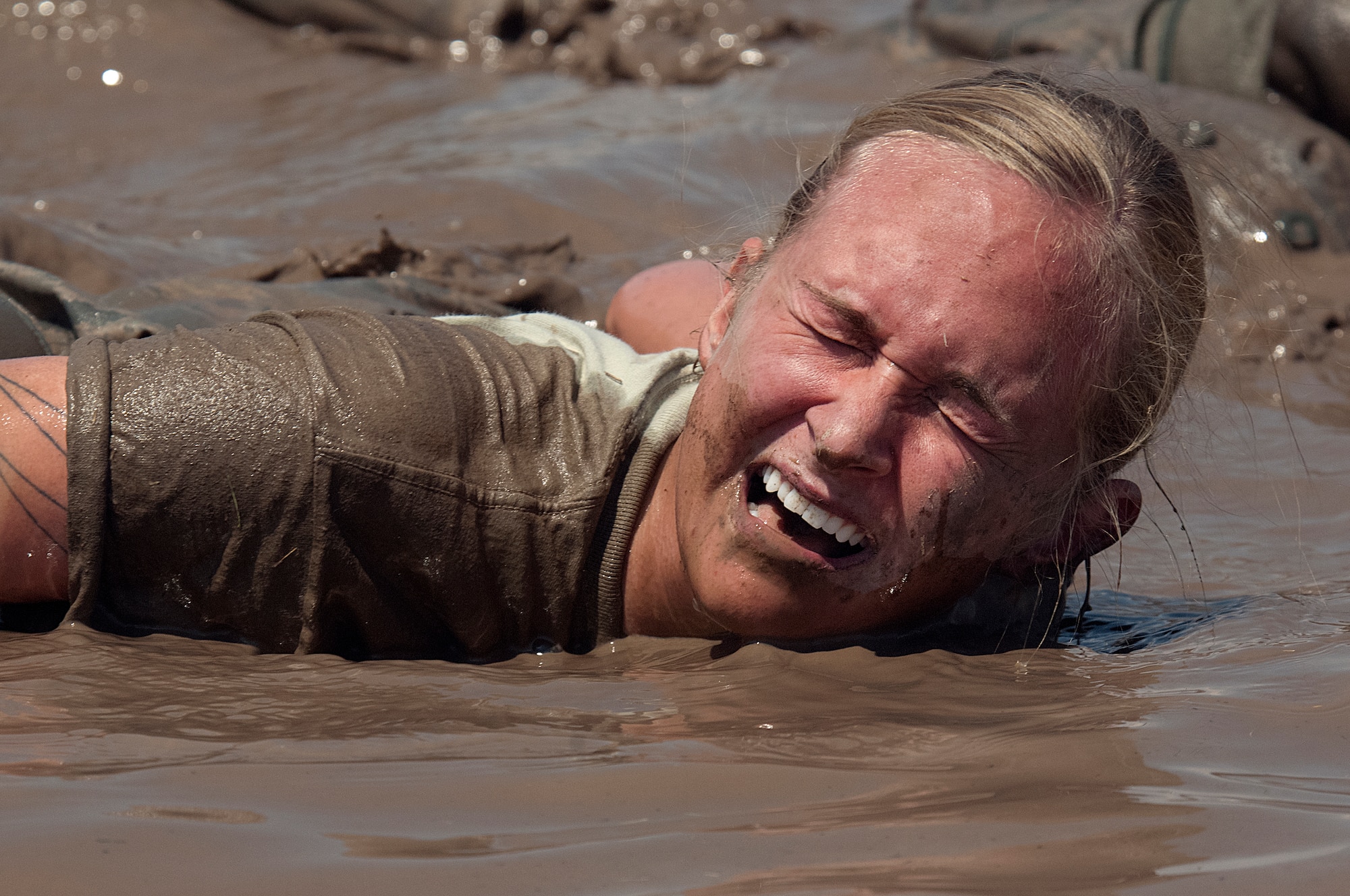 Staff Sgt. Michelle Baker, 90th Missile Security Force Squadron, tries to keep her head above water while doing team pushups in a mud hole while participating in the Team Pain section of the Crow Creek Challenge, Aug. 10. Baker took part in the annual F. E. Warren Air Force Base, Wyo., competition, which challenges 90th Security Forces Group Airmen to the limits of their physical endurance and knowledge related to their job. (U.S. Air Force photo by R.J. Oriez) 