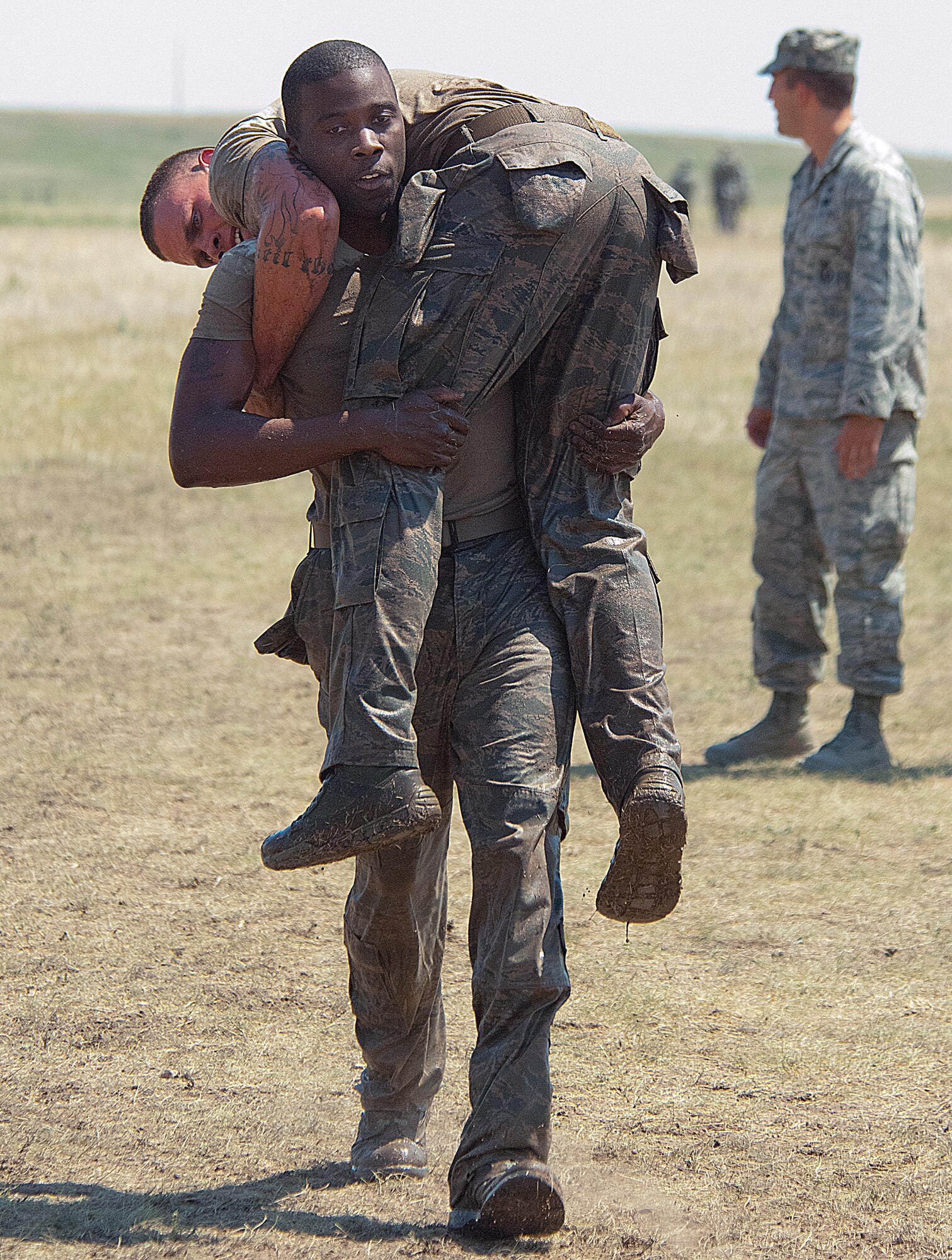 Staff Sgt. Chip Perkins carries Senior Airman Bradley Little in the Team Pain section of the Crow Creek Challenge Aug. 10. Perkins and Little were half of the 790th Missile Security Forces Squadron Convoy Response Force team who placed second in the annual Crow Creek Challenge on F. E. Warren Air Force Base, Wyo. (U.S. Air Force photo by R.J. Oriez)