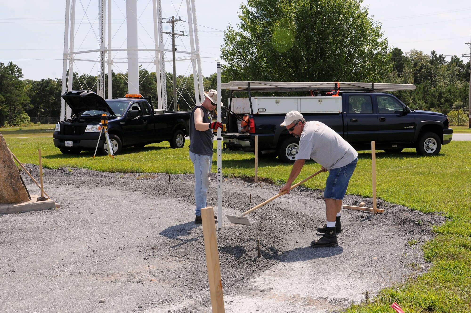 Richard Connor (left) and Christopher Lewis, 102nd Civil Engineer Squadron, level the grounds of the Otis Heritage Plaza, Aug. 14, to prepare the area for the installation of bricks. The Otis Heritage Plaza, a fundraising project, is located at the flagpole on Grandville Avenue, Otis Air National Guard Base, Mass. After completion, the plaza will be lined with custom engraved bricks memorializing the names of those who have served. The grand opening is scheduled for Family Day, Sept. 16, 2012. To find out more about purchasing a commemorative brick, visit http://www.102iw.ang.af.mil and click on the Otis Heritage Plaza brick order form. (Air National Guard photo by Tech. Sgt. Kerri Cole/Released)