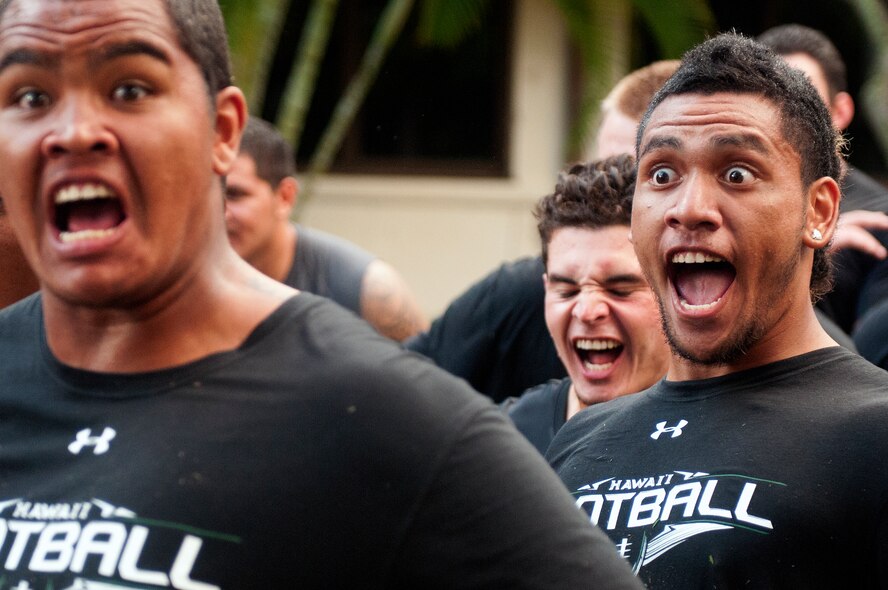 University of Hawaii Warriors football team perform a haka for the Air Force and Navy members who gave them a early morning basic training style wake-up call Aug. 14 at Joint Base Pearl Harbor-Hickam.  Former Air Force and Navy basic military training instructors gave a very special wake-up call to the University of Hawaii football team shortly after 5 a.m. for a team building exercise. (U.S. Air Force photo/Staff Sgt. Mike Meares)