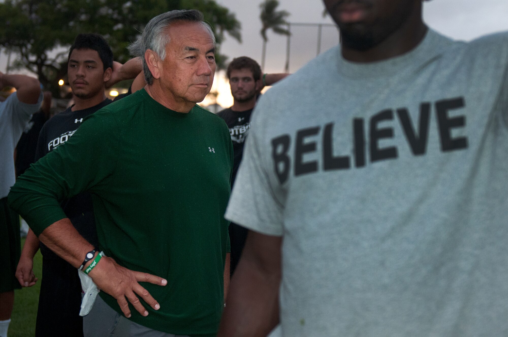 University of Hawaii head coach Norm Chow watches as the Warriors go through a physical training session Aug. 14 at Joint Base Pearl Harbor-Hickam.  Former Air Force and Navy basic military training instructors gave a very special wake-up call to the University of Hawaii football team shortly after 5 a.m. Aug. 14 for a team building exercise. (U.S. Air Force photo/Staff Sgt. Mike Meares)