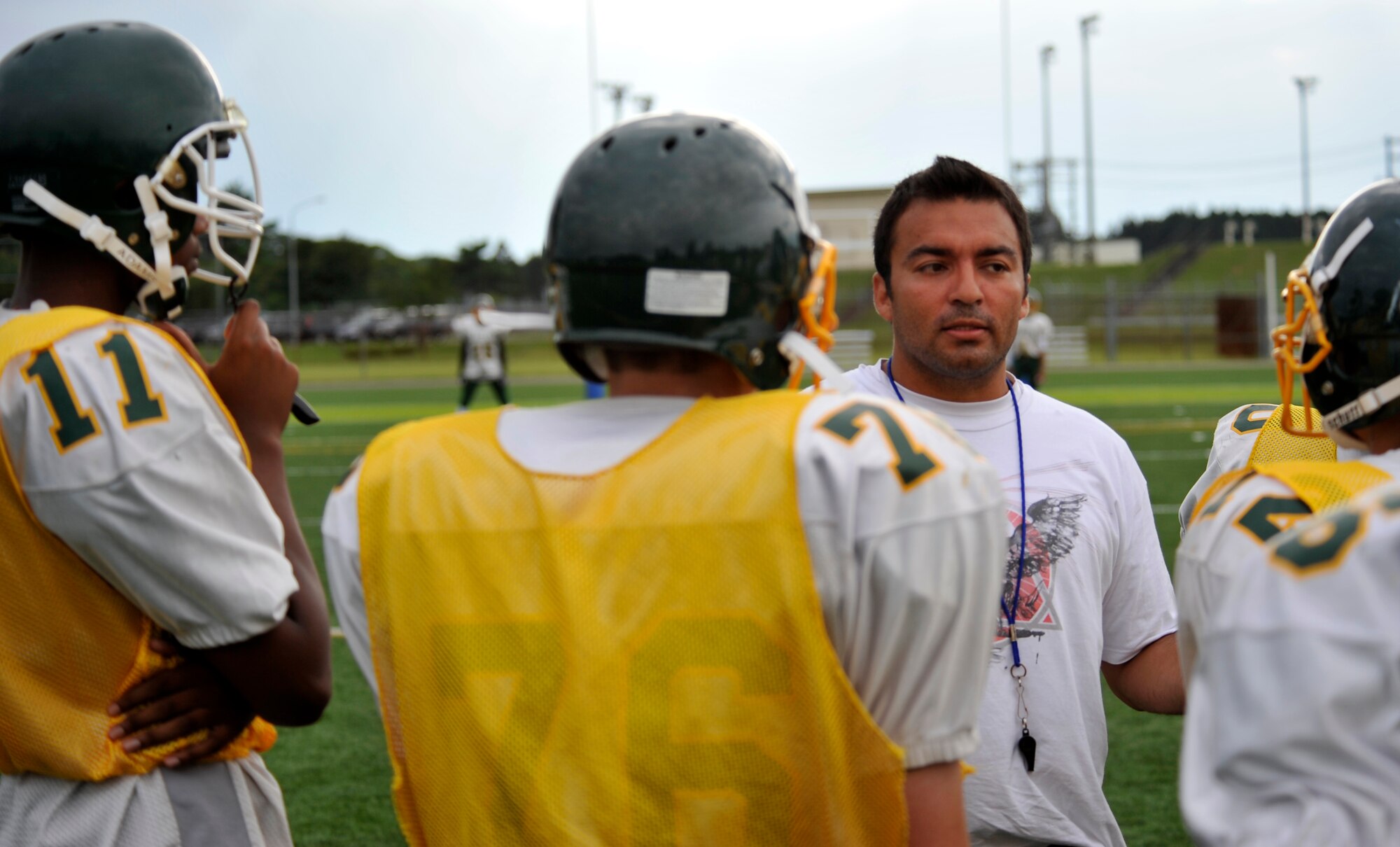 Members of the Edgren High School football team listen to Coach Gabriel Campo as he talks to them before practicing special teams during their team practice at Misawa Air Base, Japan, Aug. 15, 2012.  The football team practiced both kickoffs and kickoff returns at, along with focusing on individual positions. (U.S. Air Force photo by Airman 1st Class Zachary Kee/Released)