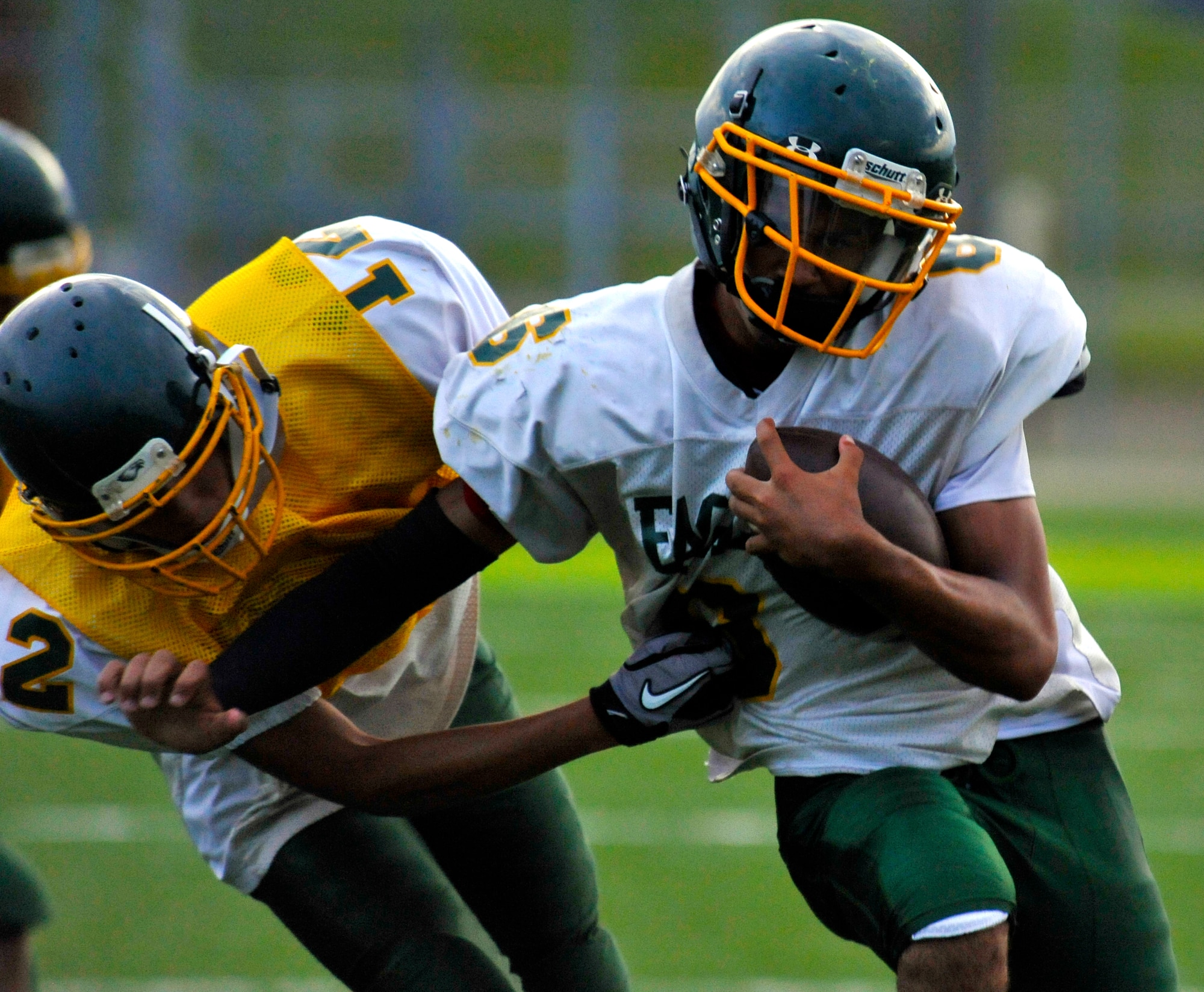 Edgren Eagles quarterback Tristan Jefferson breaks linebacker Sean Cole’s tackle during Edgren High School’s football practice at Misawa Air Base, Japan, Aug. 15, 2012. The offense and defense scrimmaged against each other to mimic real game-time situations and practice plays. (U.S. Air Force photo by Airman 1st Class Zachary Kee/Released)