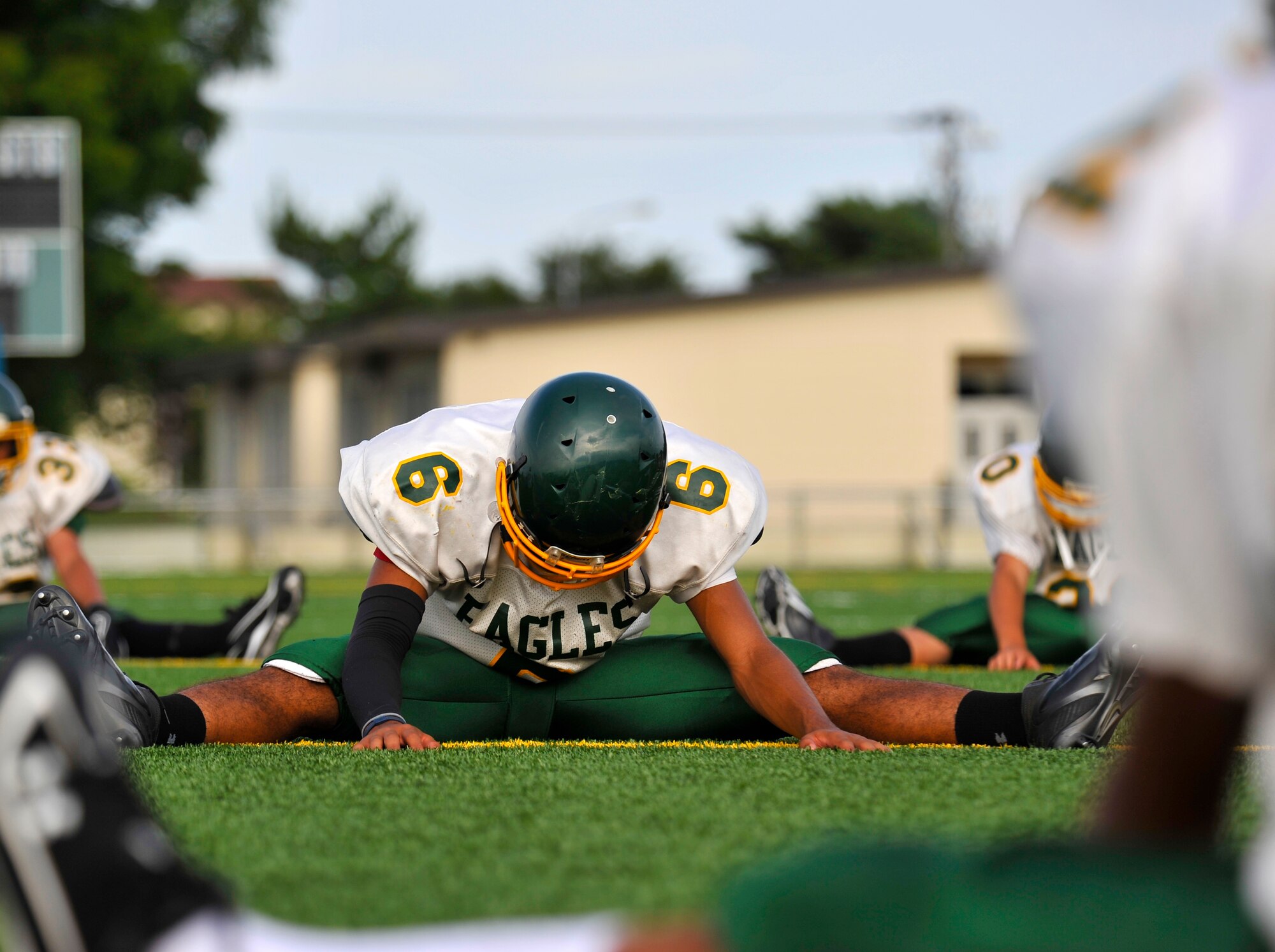Edgren Eagles quarterback Tristan Jefferson stretches before practice at Misawa Air Base, Japan, Aug. 15, 2012. Stretching helps prevent injuries on the field so the team can stay healthy and remain injury free. (U.S. Air Force photo by Airman 1st Class Zachary Kee/Released)