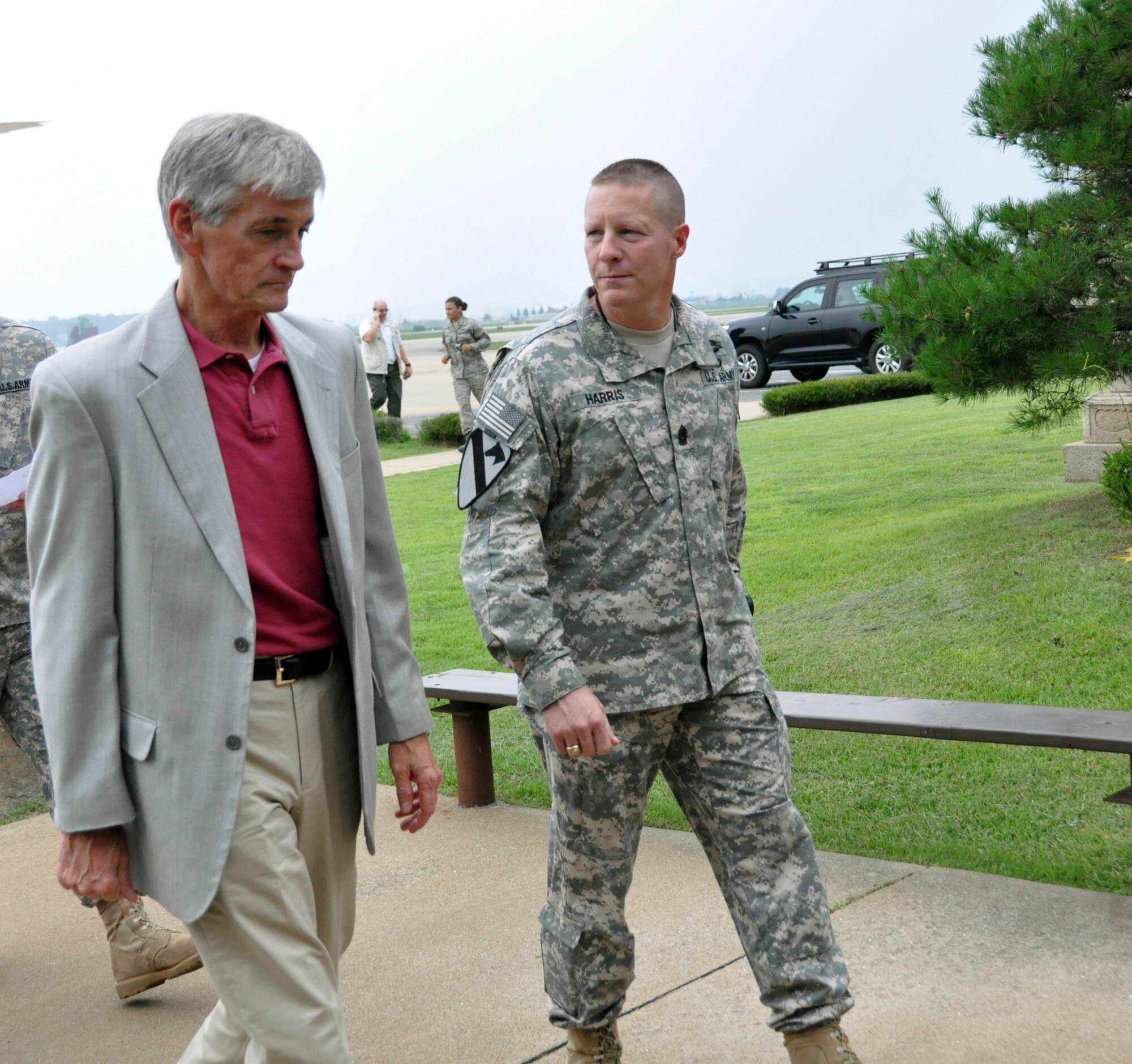 Eighth Army Command Sgt. Maj. Rodney Harris, talks with Secretary of the Army John McHugh at Osan Air Base, Republic of Korea, Aug. 16, 2012. In January, McHugh issued the general order that designated Eighth Army in Korea as an operational-level Field Army headquarters capable of commanding combined and joint corps-level combat formations. During his visit, the secretary will meet with U.S. military leaders and Soldiers around the peninsula. (U.S. Air Force photo/Senior Airman Michael Battles)
