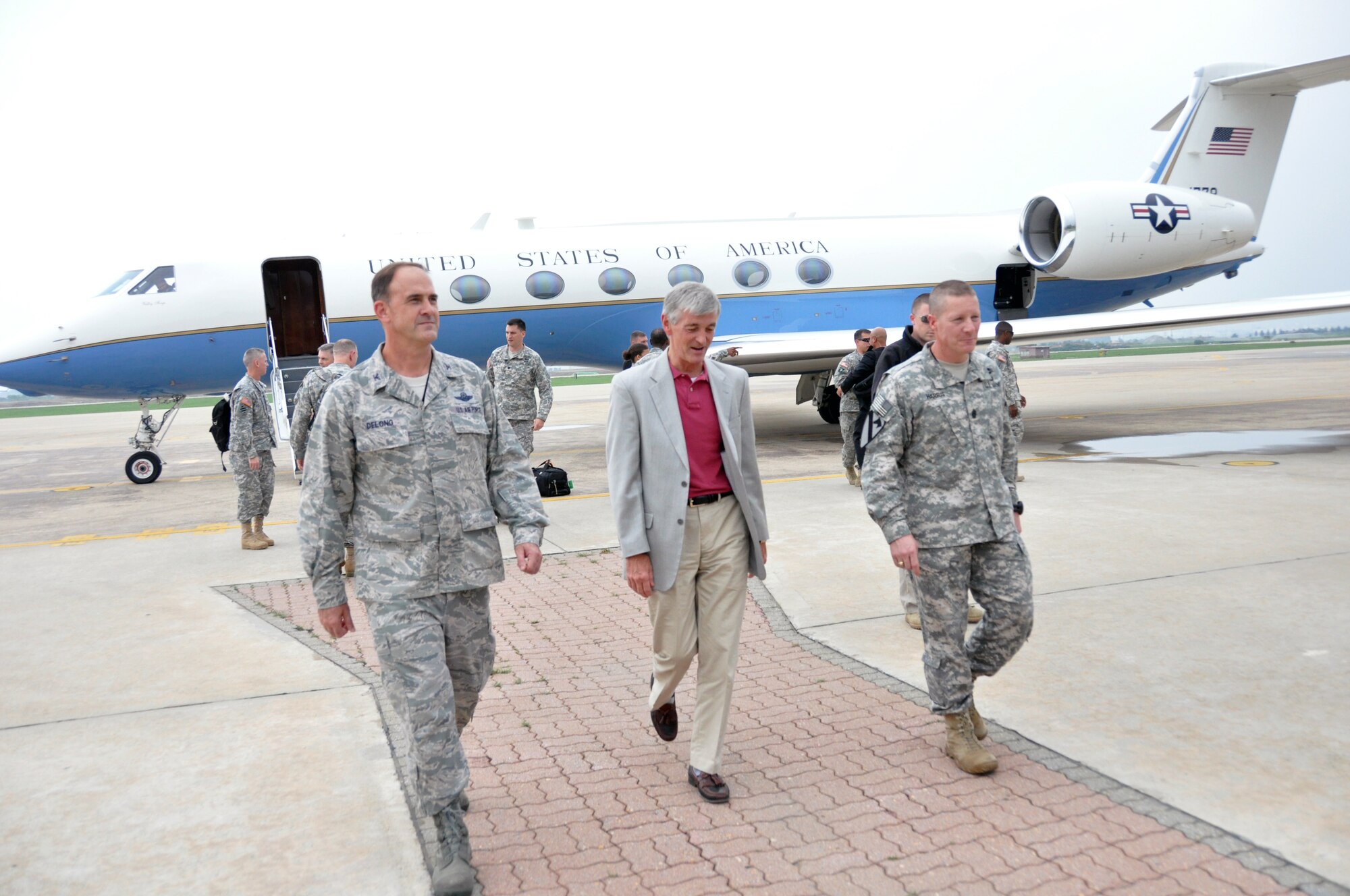 Col. Mark DeLong, 51st Fighter Wing vice commander, and Eighth Army Command Sgt. Maj. Rodney Harris, walk with Secretary of the Army John McHugh upon his arrival at Osan Air Base, Republic of Korea, Aug. 16, 2012. McHugh, who became the 21st Secretary of the Army on Sept. 21, 2009, is scheduled to meet with U.S. military leaders and Soldiers around the Korean Peninsula during his visit. (U.S. Air Force photo/Senior Airman Michael Battles) 