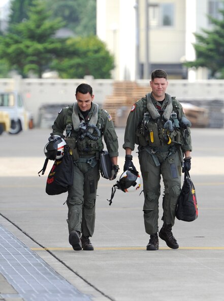 Lt. Porter Orr, a native of Scottsdale, Ariz. and Lt. Cmdr. Dan White, who hails from Boston, Mass., walk toward the flight line with gear in hand prior to the beginning of a scheduled flight at Naval Air Facility Misawa, Japan, Aug. 15, 2012. VAQ-132 is currently deployed to Naval Air Facility Misawa in support of U.S. 7th Fleet. (U.S. Navy photo by Mass Communication Specialist 2nd Class Kenneth G. Takada/Released)  