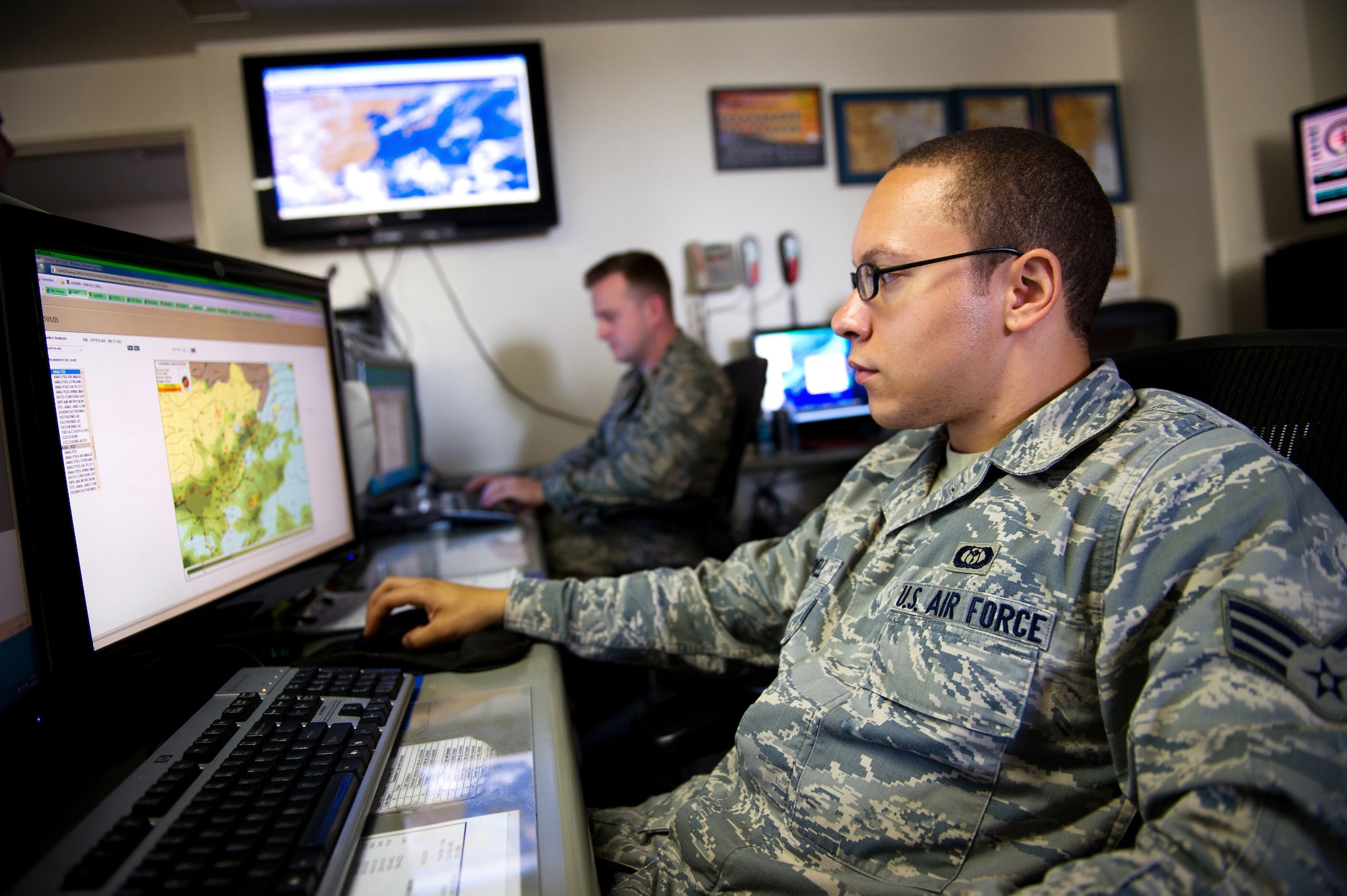 YOKOTA AIR BASE, Japan -- Senior Airman Demetreus Newell, 374th Operations Support Squadron mission execution forecaster, checks weather conditions throughout Japan Aug. 16, 2012, at Yokota Air Base, Japan. Newell must constantly check weather conditions to ensure pilots have the most up-to-date information prior to and during flights. (U.S. Air Force photo by Staff Sgt. Chad C. Strohmeyer)