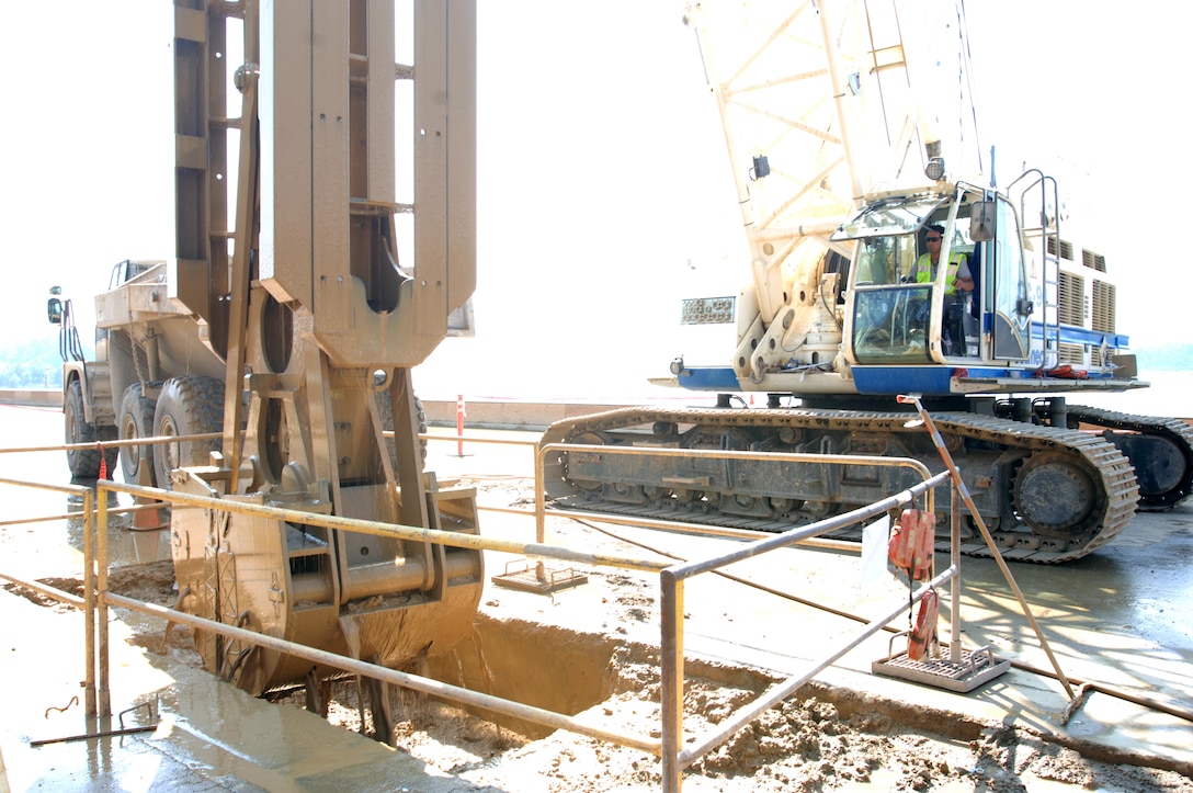 JAMESTOWN, Ky. — A construction worker operates heavy machinery and removes dirt to prepare for drilling on the work platform at Wolf Creek Dam May 2, 2012. The U.S. Army Corps of Engineers Nashville District is installing a barrier wall into the embankment at the dam to stop seepage in the foundation.