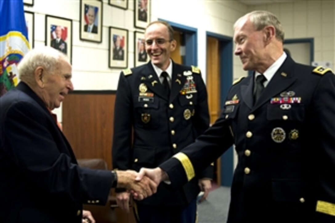 Retired Army Gen. John W. Vessey Jr., left, who served as the 10th chairman of the Joint Chiefs of Staff, greets Army Gen. Martin E. Dempsey, right, the 18th chairman of the Joint Chiefs of Staff, as Army Lt. Col. Mark Weber looks on at the Minnesota National Guard Armory in Rosemount, Minn., Aug. 16, 2012. The two generals were attending Weber's end of service ceremony. 
