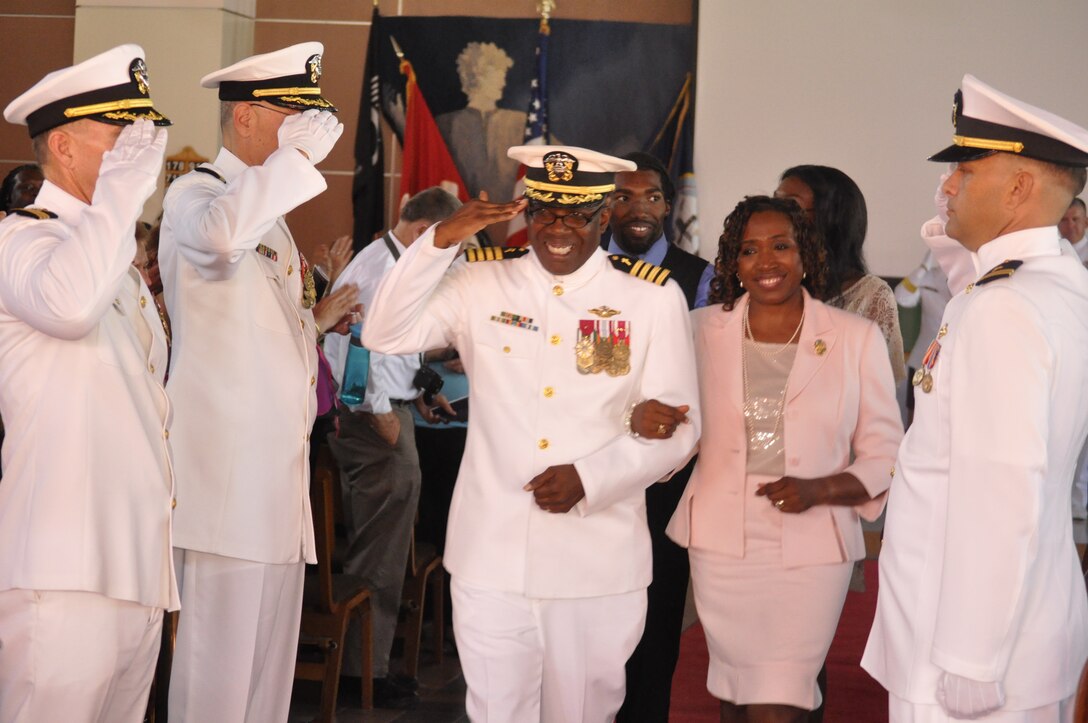 Navy Capt. Ollis J. Mozon, Jr., the Marine Corps Installations-West and Marine Corps Base Camp Pendleton chaplain, salutes as he goes "ashore" with his family for the last time during his retirement ceremony at the Blinder Memorial Chapel here, Aug. 17. Mozon, retired after 30 years of service.