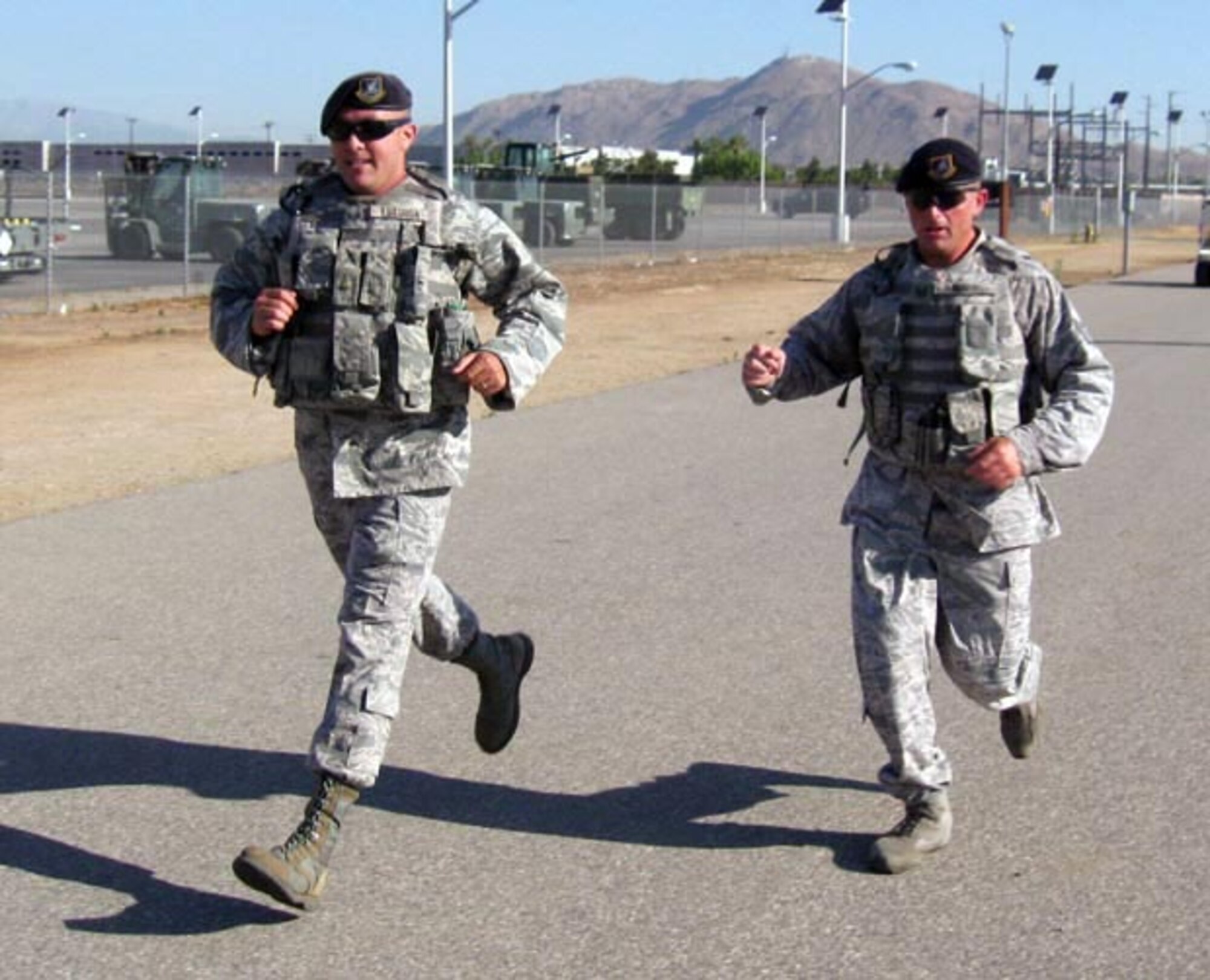Tech. Sgt Michael Hammers and Staff Sgt. Mark Estorga, 452nd Security Forces Squadron, ran the 10K wearing ABU’s and gear during the Wounded Warrior 5K/10K Run/Walk at the March Air Reserve Base, Fit 2 Fight track, Aug. 7. 452nd Honor Guard ran the 5K run time 29:30. (U.S. Air Force photo)