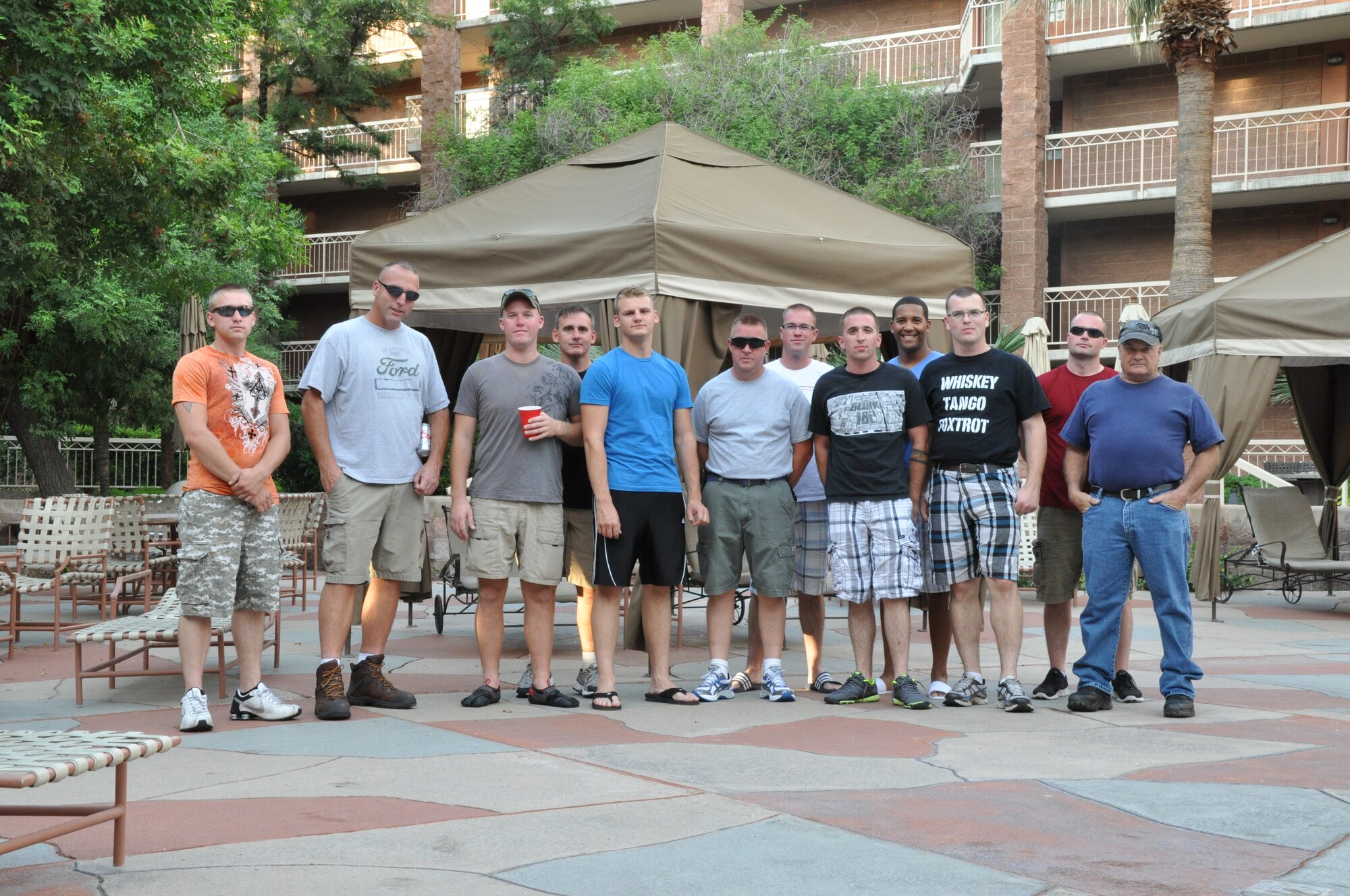 TUCSON, AZ - Members of the 442nd Aircraft Maintenance Squadron from Whiteman Air Force Base, Mo., display their camaraderie by comparing notes while off-duty during Hawgsmoke.  Aug. 15, 2012. Hawgsmoke is an international biennial competition, with 60 aircraft from 17 A-10 units. The host unit was Davis-Monthan Air Force Base, Ariz. (U.S. Air Force photo by Staff Sgt. Lauren Padden/Released)