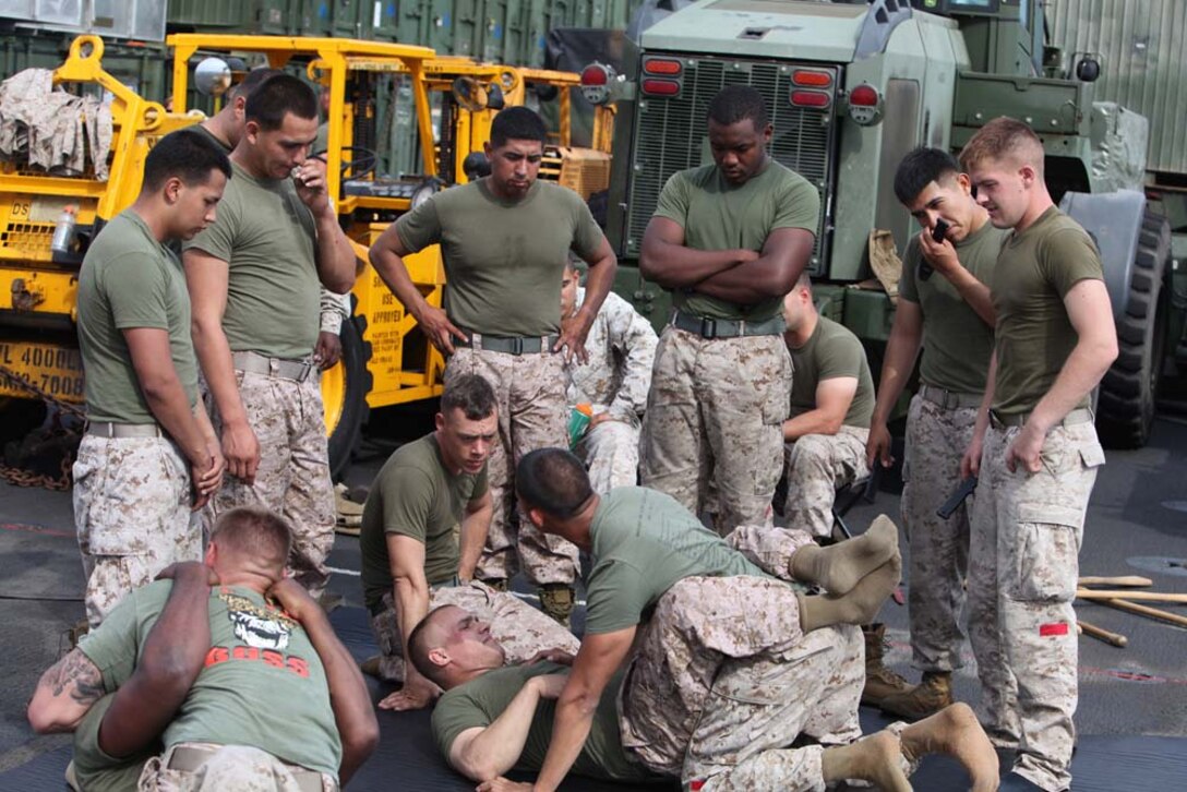 Marines from Combat Logistics Battalion 15, 15th Marine Expeditionary Unit, grapple during Marine Corps Martial Arts Program training on the flight deck of the USS Rushmore, Aug. 16. The 15th MEU is embarked as part of the Peleliu Amphibious Ready Group during Certification Exercise, their final training before their deployment this fall.