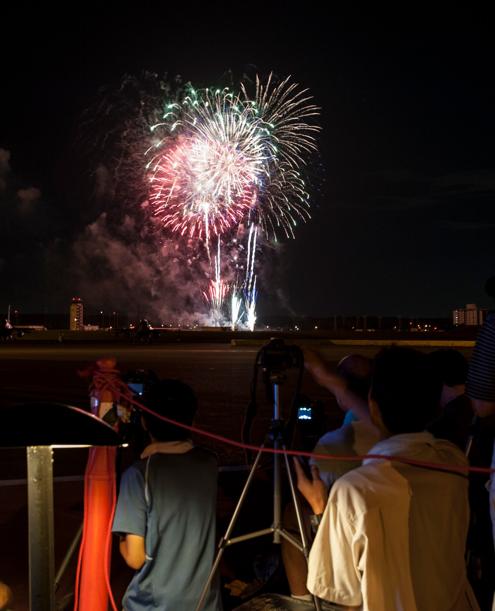 YOKOTA AIR BASE, Japan -- Visitors watch and photograph fireworks bursting over Yokota Air Base, Japan, on Aug. 19, 2012, during the 2012 Japanese-American Friendship Festival.  Yokota ended the two-day festival with Japan's and America's national anthems, followed by a  grand finale of fireworks. (U.S. Air Force photo by Senior Airman Andrea Salazar)