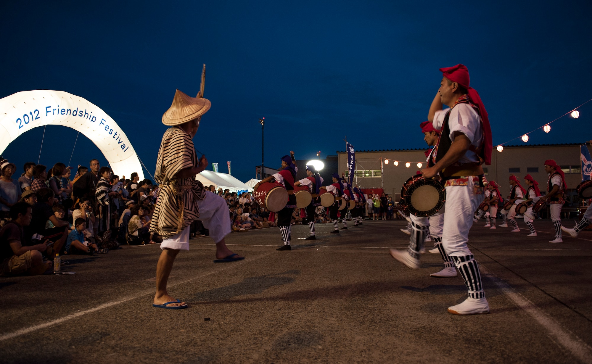 YOKOTA AIR BASE, Japan -- Japanese men play the paranku, a type of small frame drum, while performing an alternating angular Eisa dance in rows during the 2012 Japanese-American Friendship Festival at Yokota Air Base, Japan, on Aug. 18, 2012. Eisa is based on folk songs of Okinawa accompanied by joyous shouts and whistles. (U.S. Air Force photo by Senior Airman Andrea Salazar)