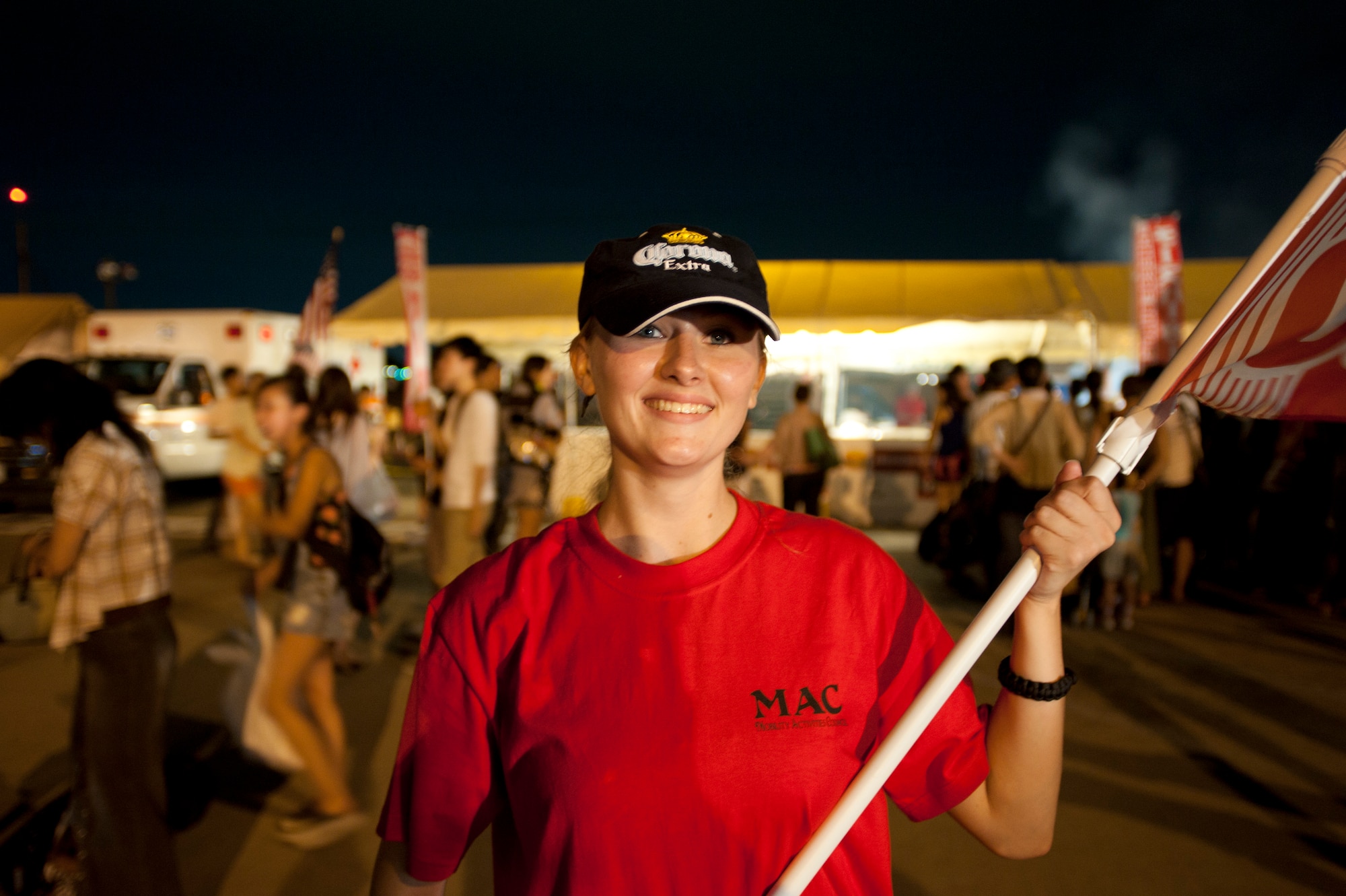 YOKOTA AIR BASE, Japan -- Senior Airman Melanie Leydon, 730 Air Mobility Squadron, holds a sign advertising her booth’s food at the 2012 Japanese-American Friendship Festival held at Yokota Air Base, Japan, on Aug. 18, 2012. “I love being at the festival,” Leydon said. “I can’t wait until next year’s!” (U.S. Air Force photo by Airman 1st Class John D. Partlow)