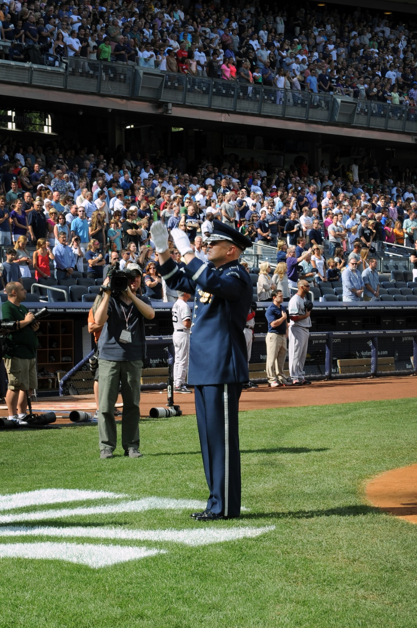 The U.S. Air Force Band Commander and Conductor Col. Larry Lang conducts The Ceremonial Brass during the opening ceremony for the Yankees vs. Red Sox game Aug. 18 at the Yankee Stadium, Bronx, N.Y. The performance kicked off the ceremonial unit’s participation in Air Force Week 2012. (U.S. Air Force photo by Senior Airman Tabitha N. Haynes) 