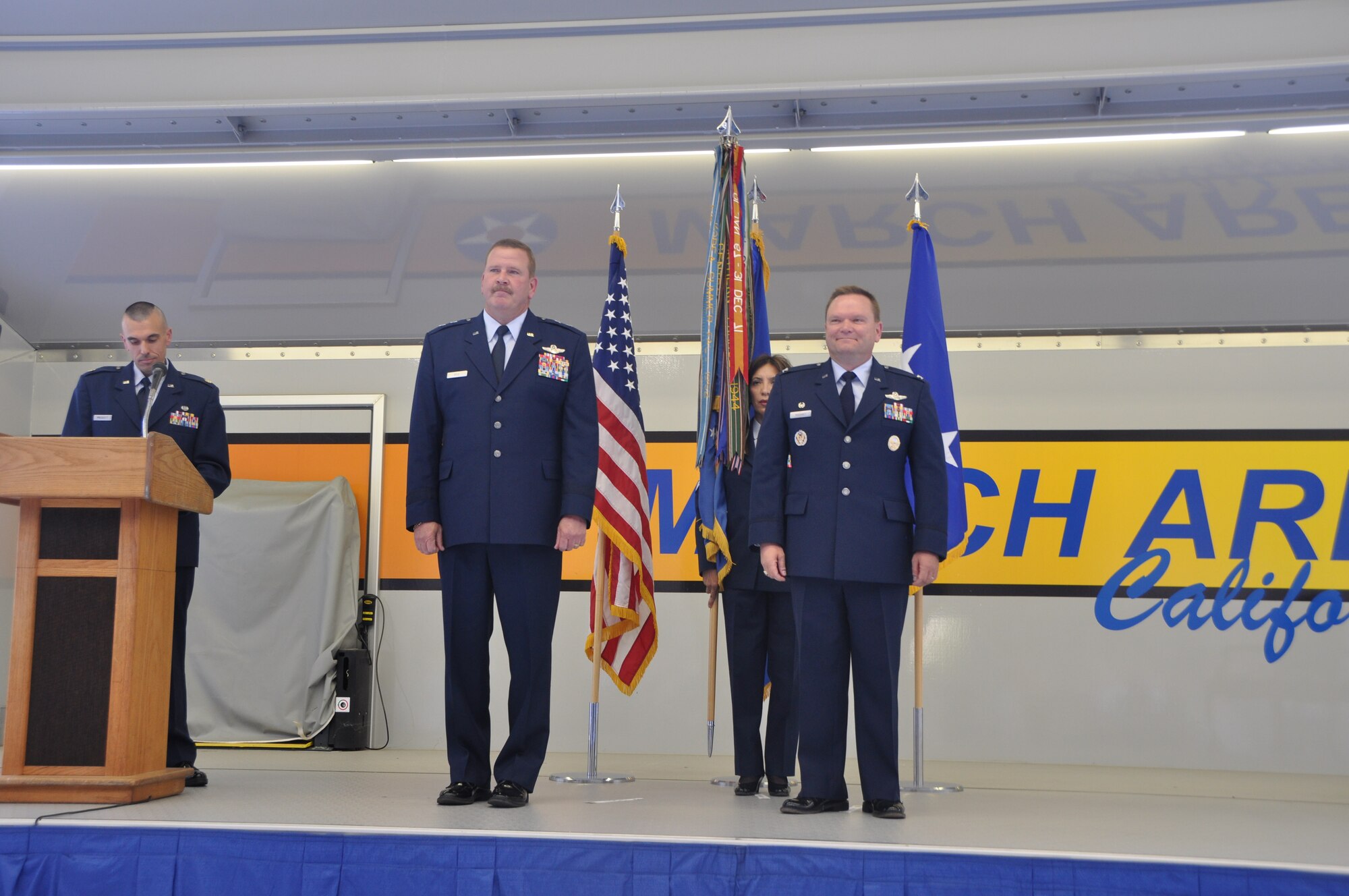 Col. Samuel C. Mahaney, right, commander, 452nd Air Mobility Wing, takes command of the 452nd Air Mobility Wing, March Air Reserve Base, Calif. from Major General Mark A. Kyle, left, commander, 4th Air Force. The flag symbolizes the transfer of authority from the old to the new commander. Command Chief Master Sgt. Ericka E. Kelly, wing command chief, assisted with the flag transfer.  (U.S. Air Force photo by Senior Airman Isis Ponce)