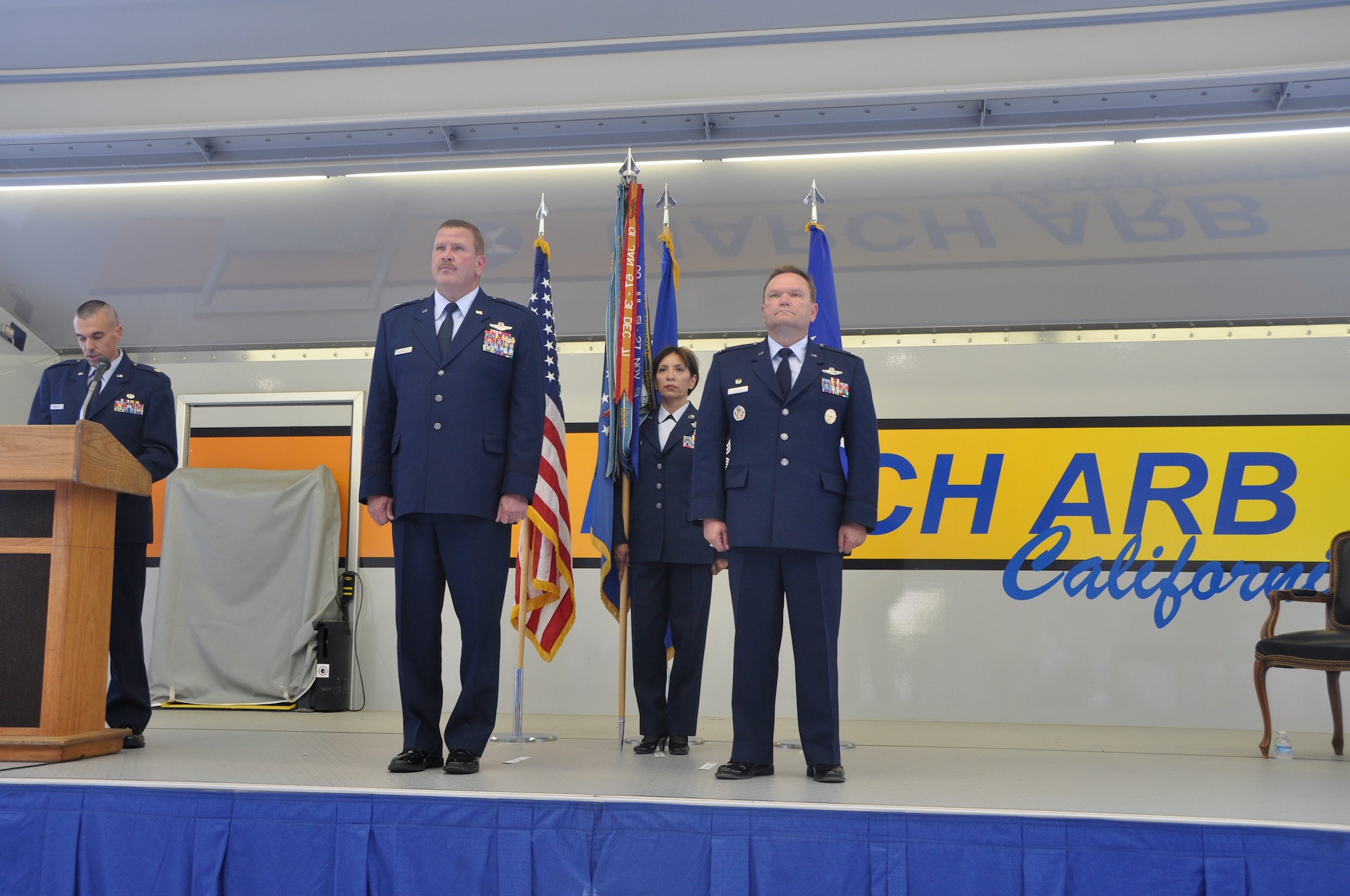 Col. Samuel C. Mahaney, right, commander, 452nd Air Mobility Wing, takes command of the 452nd Air Mobility Wing, March Air Reserve Base, Calif. from Major General Mark A. Kyle, left, commander, 4th Air Force. The flag symbolizes the transfer of authority from the old to the new commander. Command Chief Master Sgt. Ericka E. Kelly, wing command chief, assisted with the flag transfer.  (U.S. Air Force photo by Senior Airman Isis Ponce)