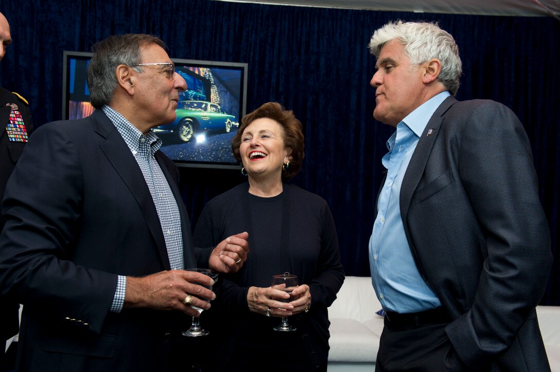 Defense Secretary Leon E. Panetta, left, and his wife, Sylvia, speak with comedian Jay Leno at a car auction in Monterey, Calif., Aug. 18, 2012. Panetta and Leno, along with Army Chief of Staff Gen. Ray Odierno, attended Leno's auction of his Fiat 500 Prima Edizione car to benefit the Fisher House Foundation.