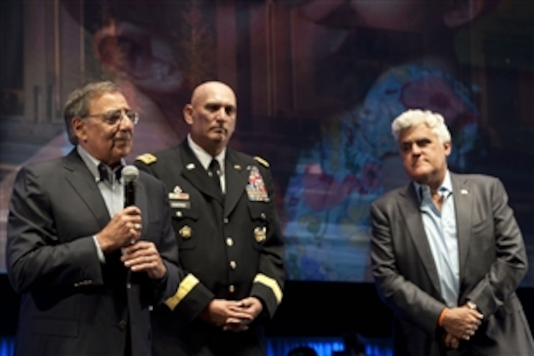 Defense Secretary Leon E. Panetta speaks as Army Chief of Staff Gen. Ray Odierno and comedian Jay Leno listen during a car auction in Pebble Beach, Calif., Aug. 18, 2012. Panetta and Odierno attended the auction of the Fiat 500 Prima Edizione to benefit the Fisher House Foundation, a nonprofit organization that helps veterans and wounded warriors.  
