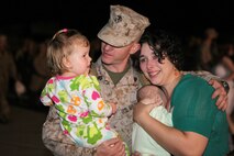 Sgt. Mathew S. Dunlap, an airframes collateral duty quality assurance representative with Marine Medium Tiltrotor Squadron 365, hugs his family after returning from a 7-month deployment to Afghanistan, Aug. 1.  During VMM-365's deployment, they supported ground units while conducting flight operations.
