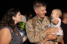Capt. Joel Vandenende, a pilot with Marine Medium Tiltrotor Squadron 365, greets his family after having not seen them for seven months while on deployment in Afghanistan, Aug. 1. More than 200 Marines came back from deployment with VMM-365.
